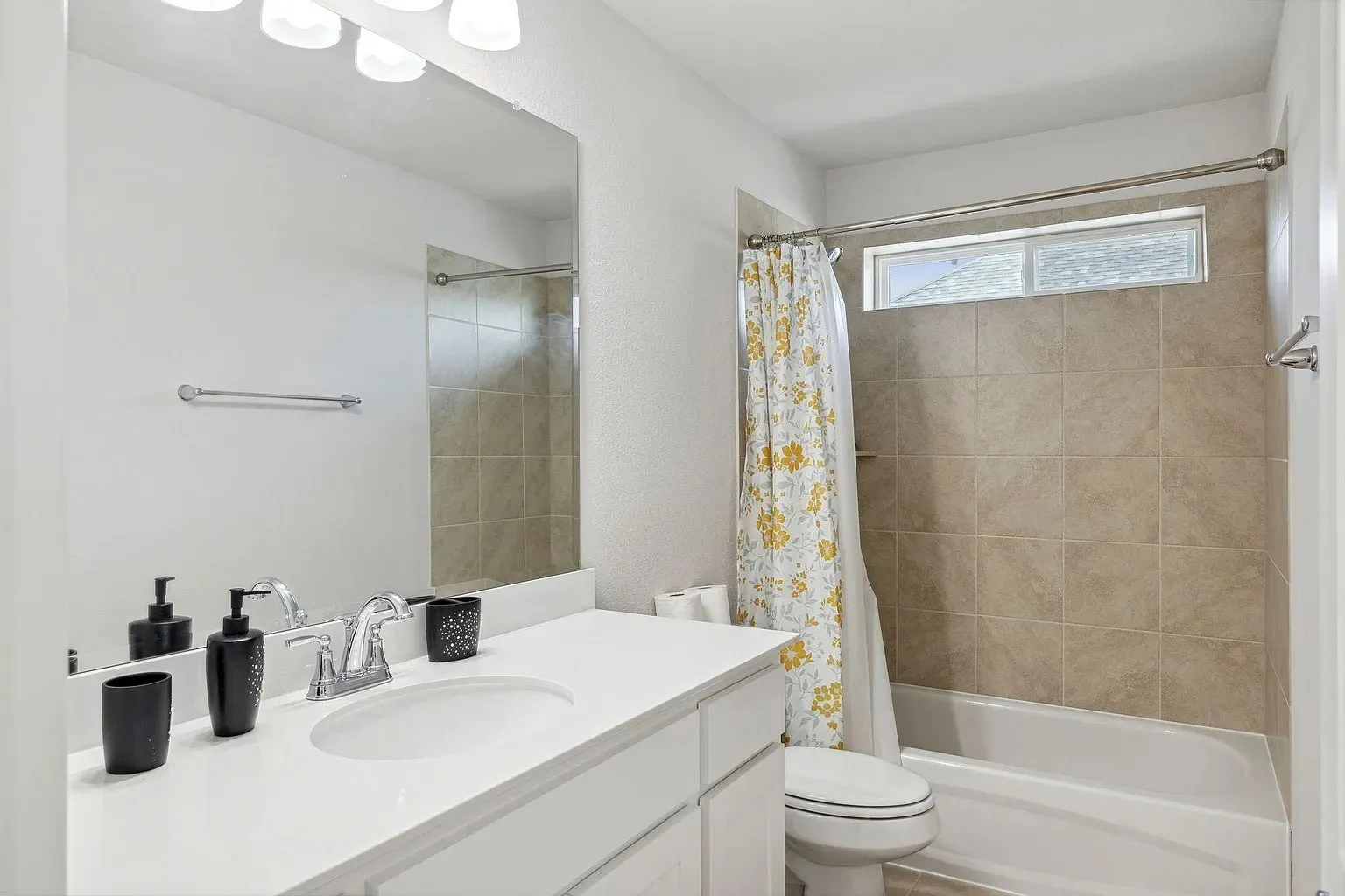 Bathroom featuring a single vanity with an integrated sink, white countertop, and chrome faucet