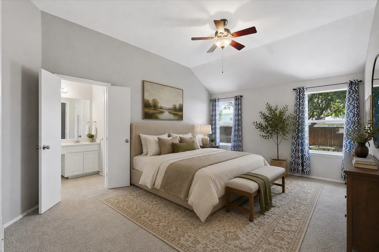 Vaulted ceiling, ceiling fan, carpet flooring, dual windows, and an en-suite bathroom with a double vanity. Virtually Staged.