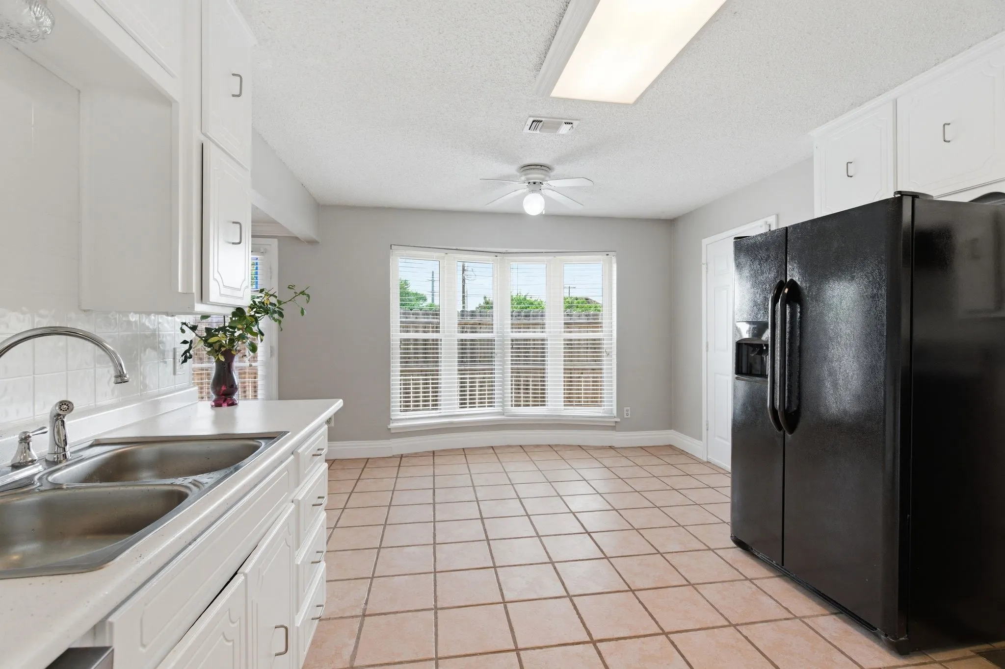 Bright galley kitchen with great cabinet storage and a charming breakfast nook with bay window