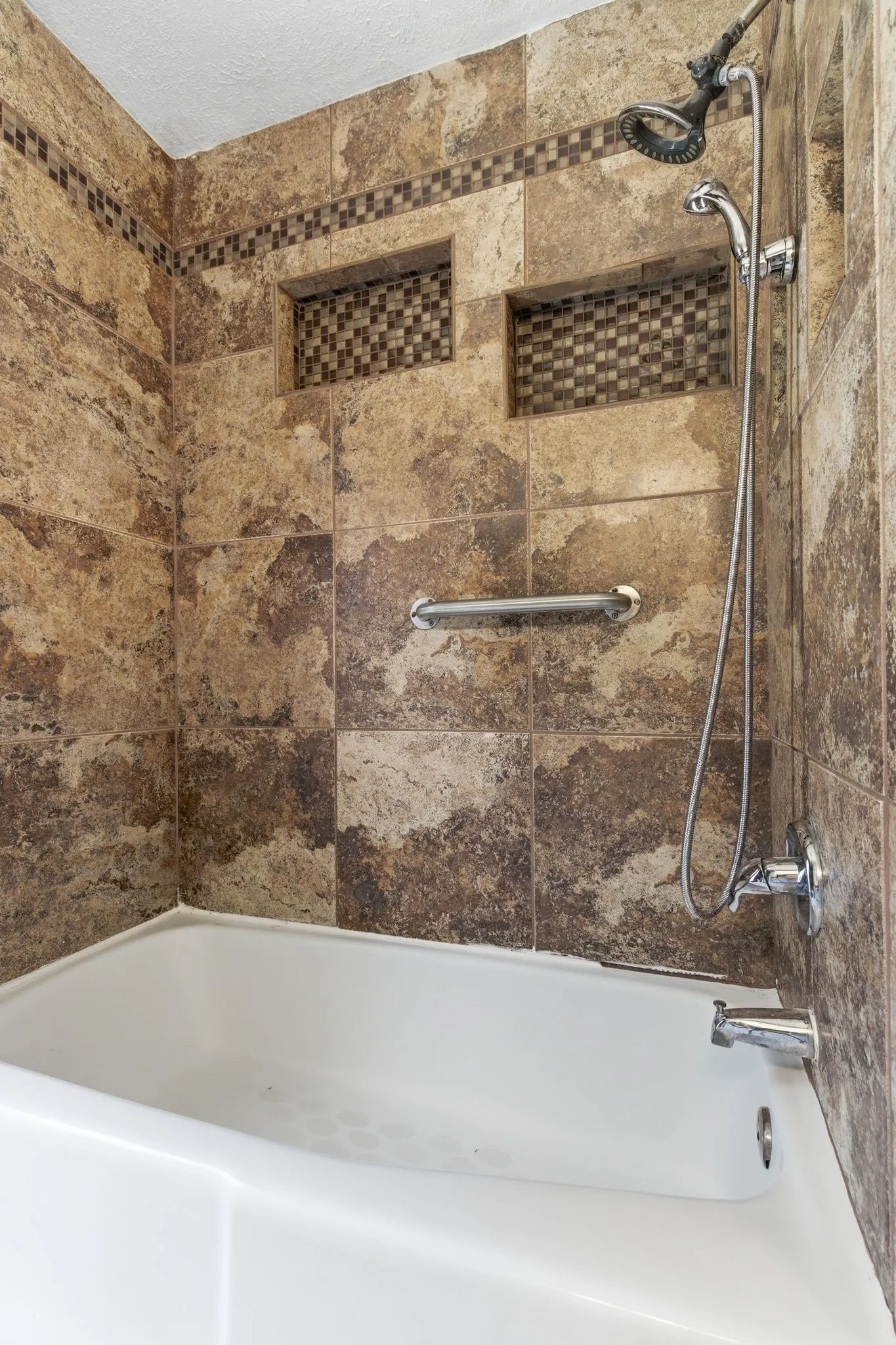 Tile surround with built-in storage niches.