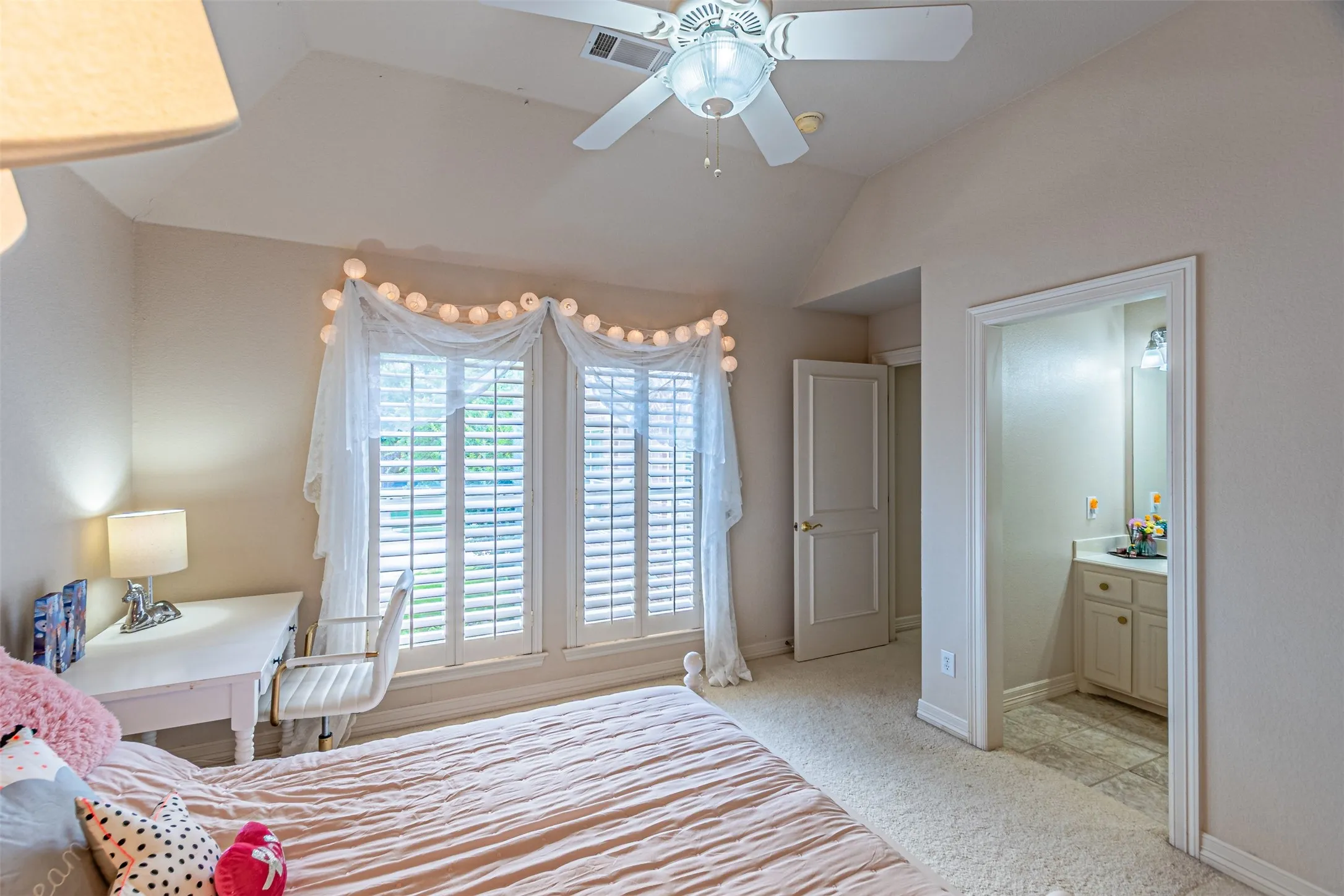 Room featuring vaulted ceilings and a ceiling fan with integrated lighting