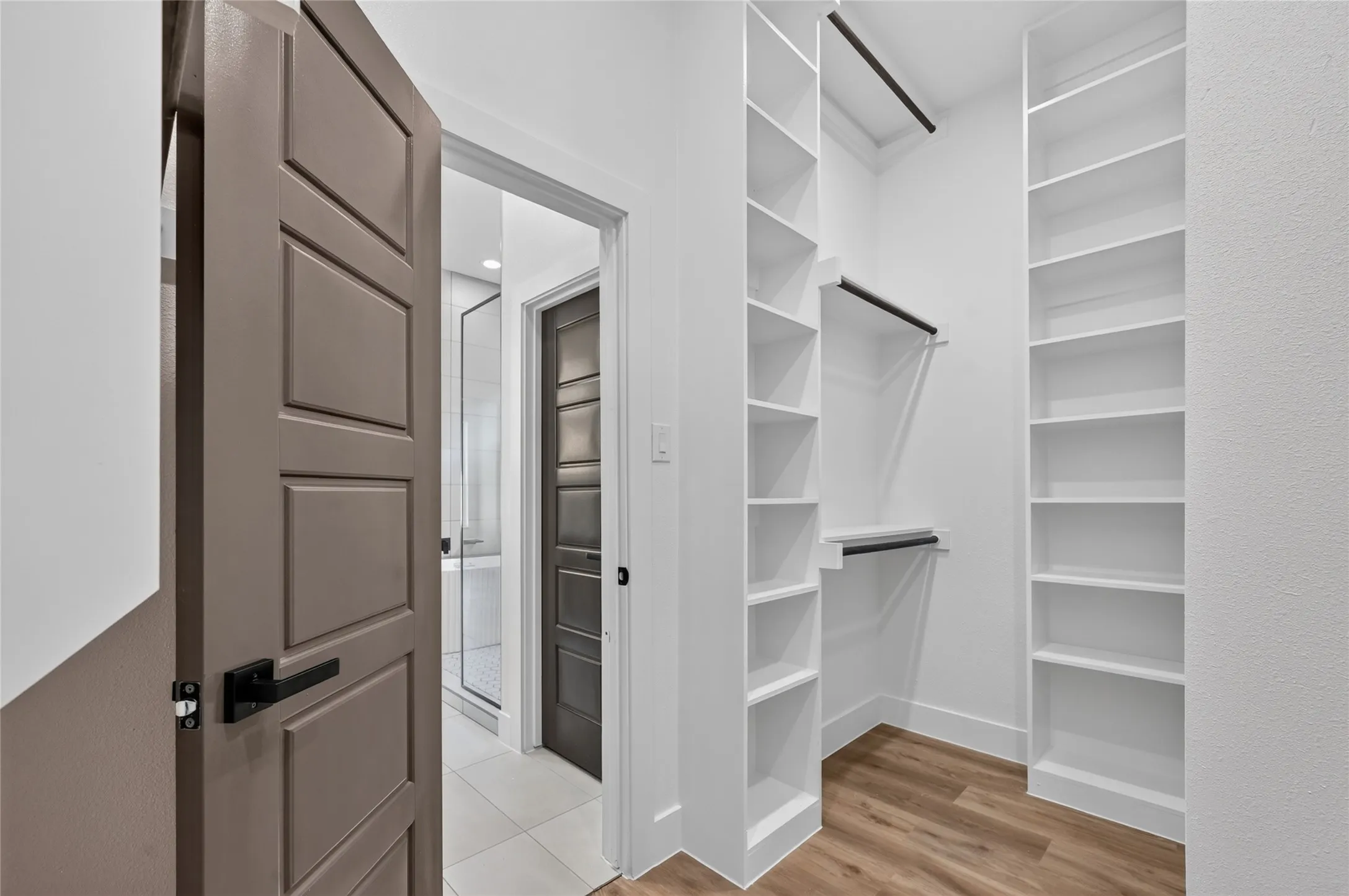 Custom closet system featuring extensive shelving and hanging rods