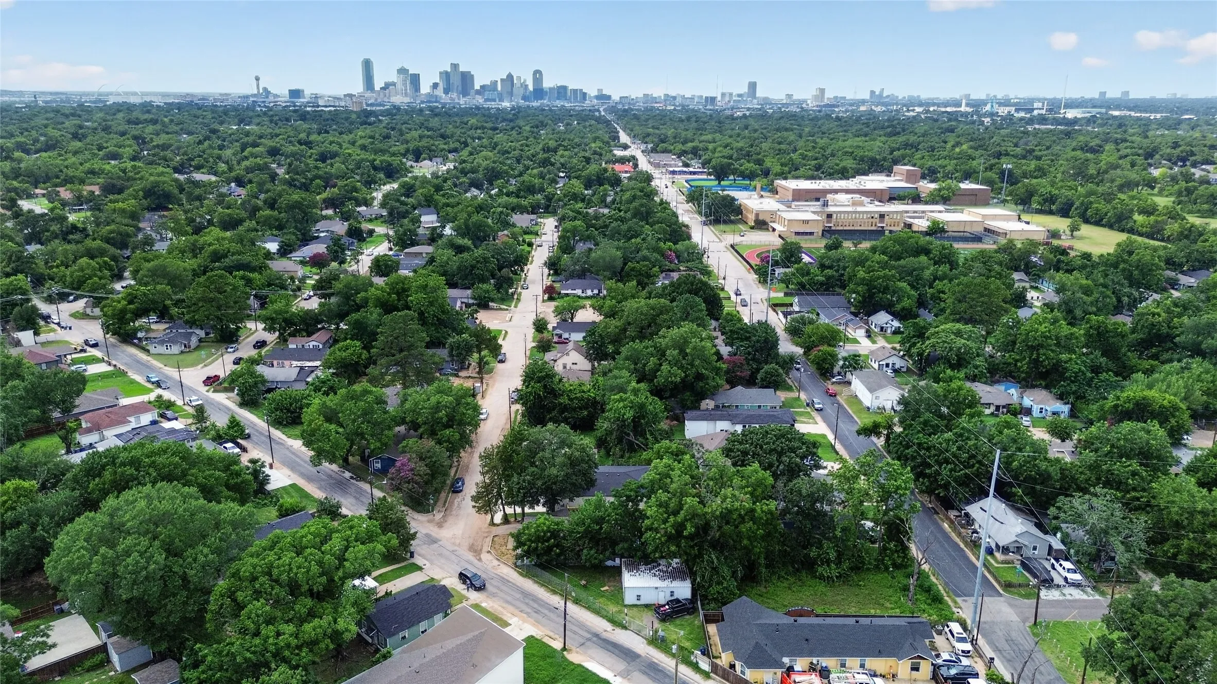 Aerial perspective showcasing a residential area with extensive tree canopy