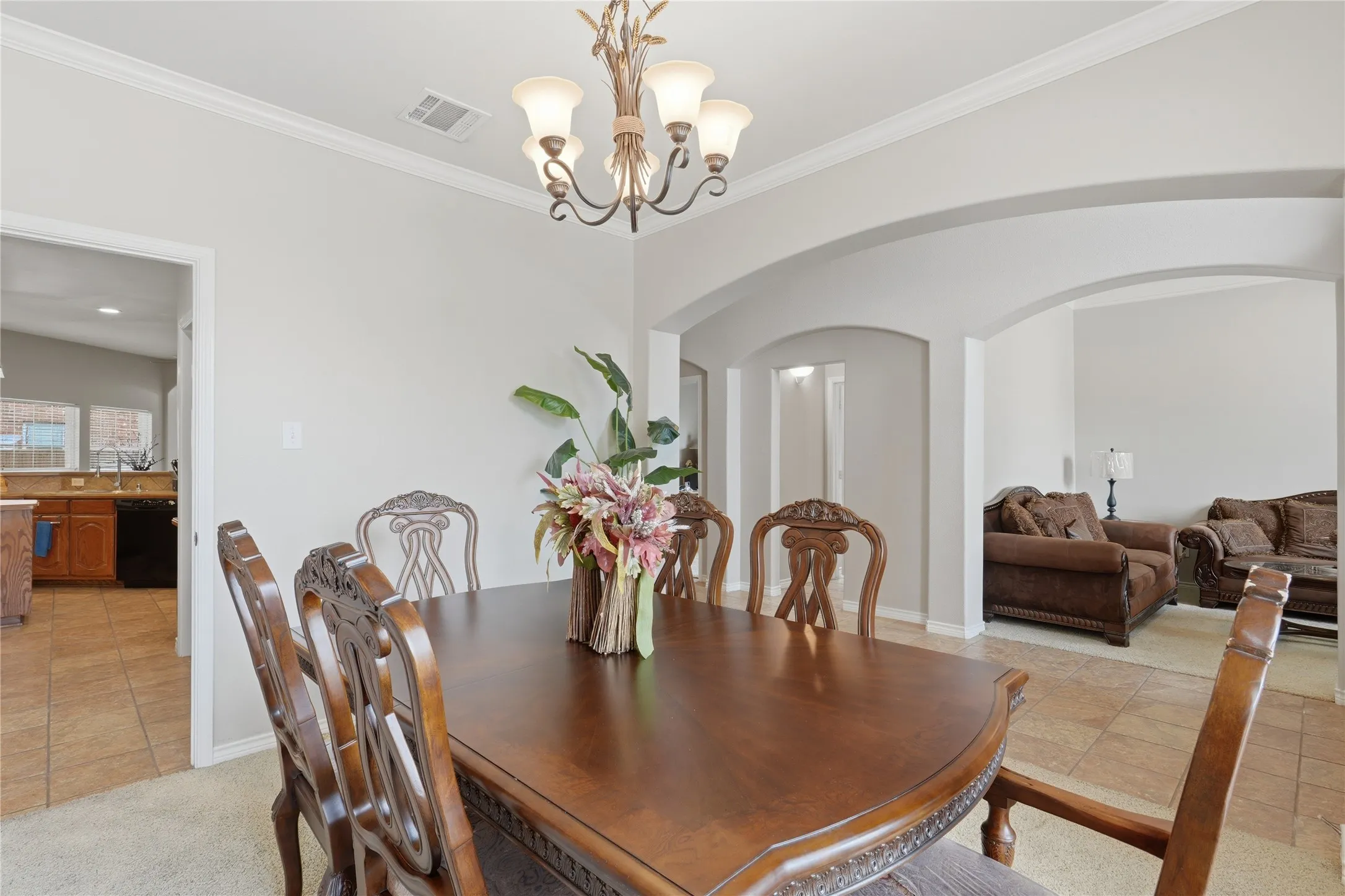 Dining area with neutral wall paint and crown molding
