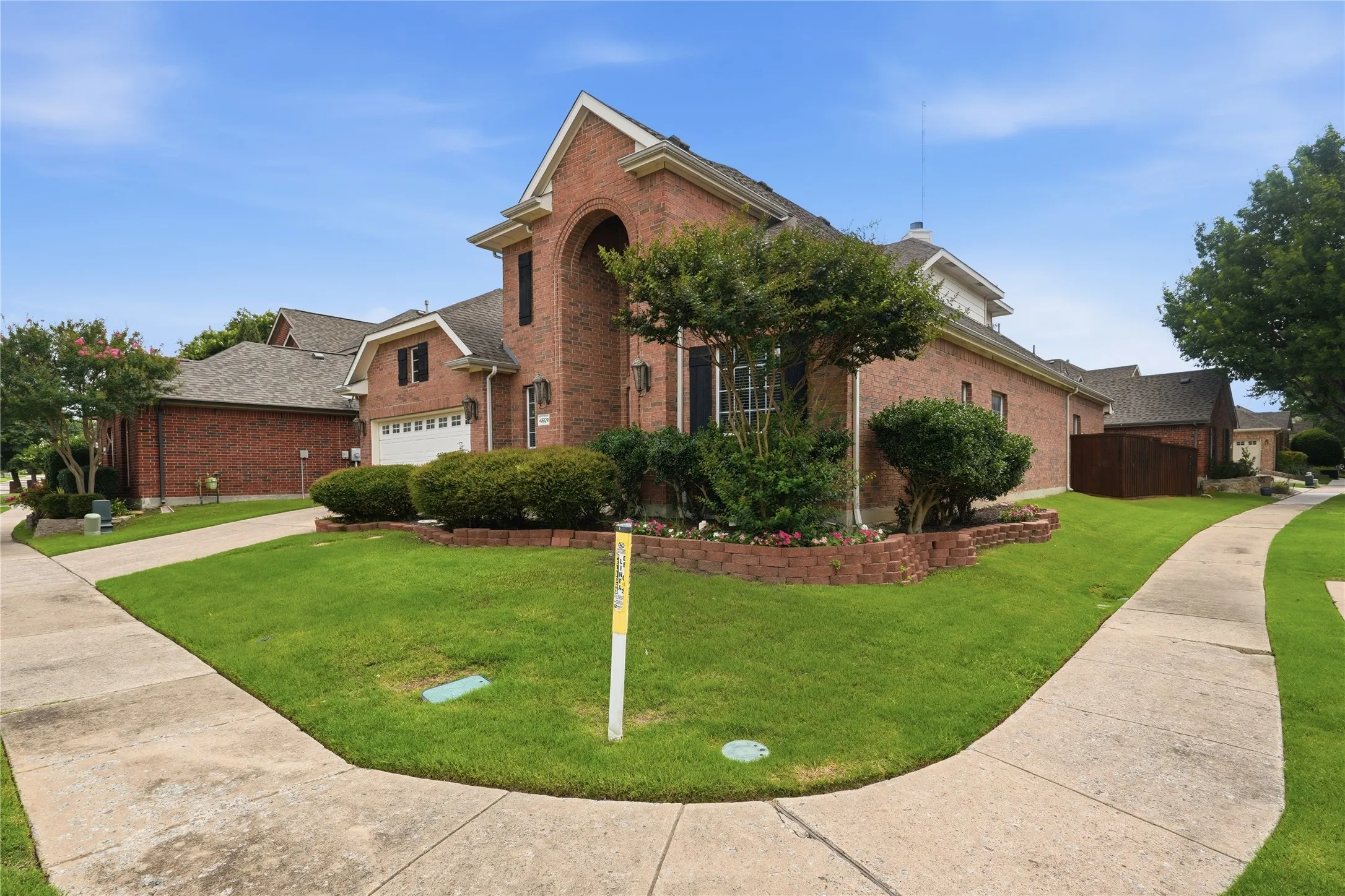 Brick exterior with an arched entryway and gabled roofline
