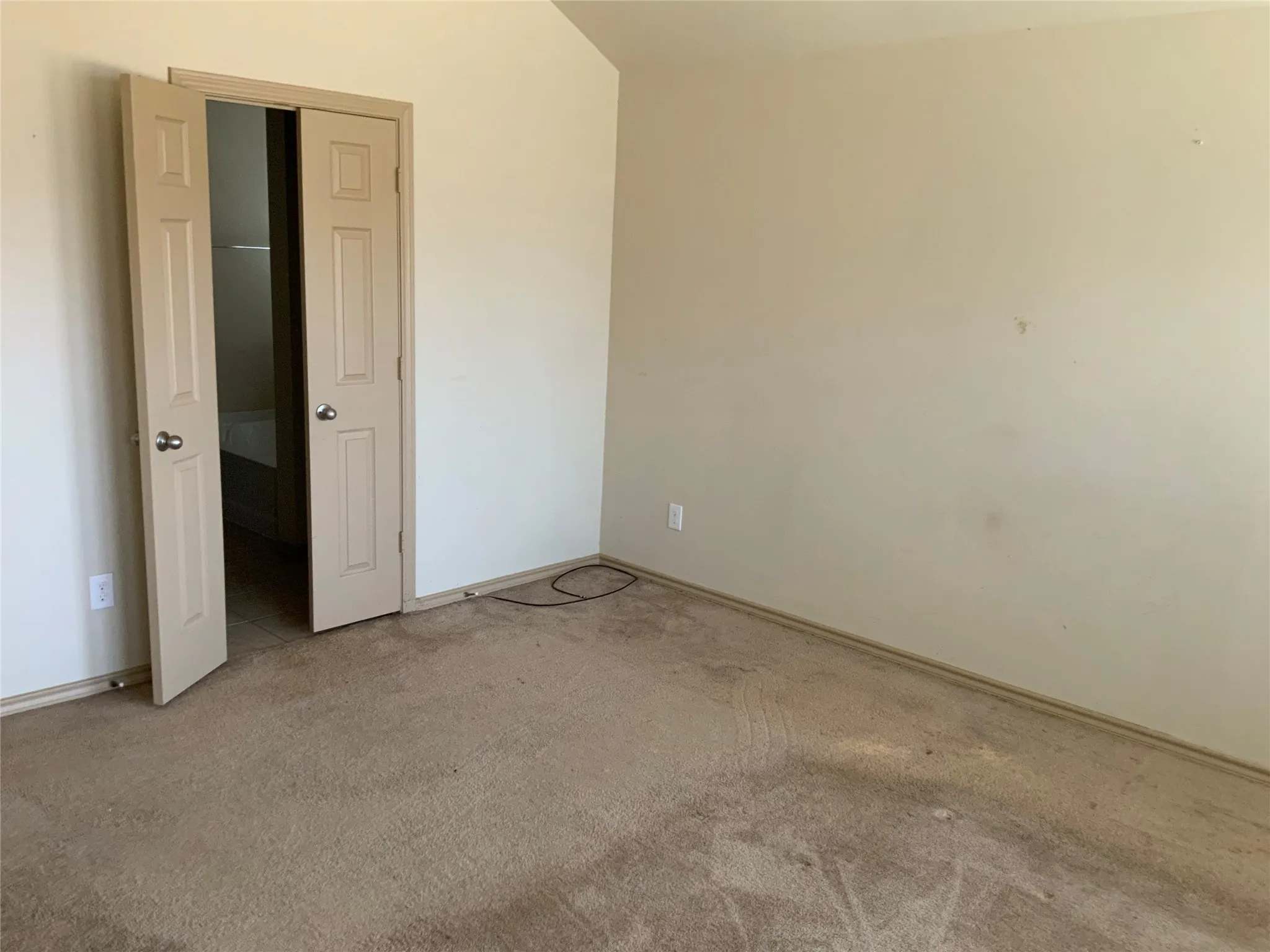 Neutral-toned walls complement the carpeted flooring