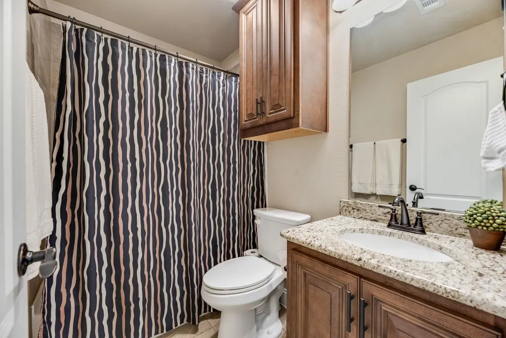 This is the 3rd Full Bathroom - Single Sink with Granite Countertop, Cabinet Hardware Added, Tub Shower Combination with Tile Surround. Ceramic Tile Flooring. Decorative Lighting