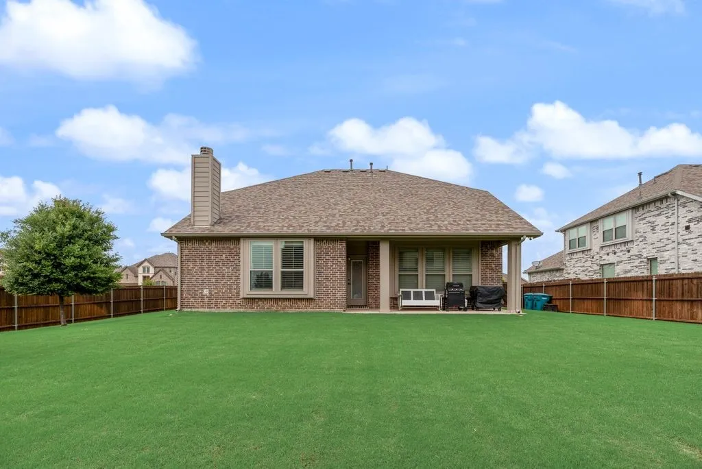 Partial View of Backyard - Big Backyard - Fully Sodded with Sprinkler Zones.  Nice Under Roof Covered Back Porch and Wood Fencing. Wood Fence was re -stained in 2025.