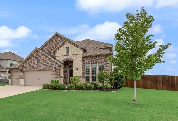 Front Exterior View 5 - Well Maintained Yard - Fence Re-stained in 2025. Sprinkler Systems Serviced 2026. Additional Coach Lighting and Garage Hardware Added while building.