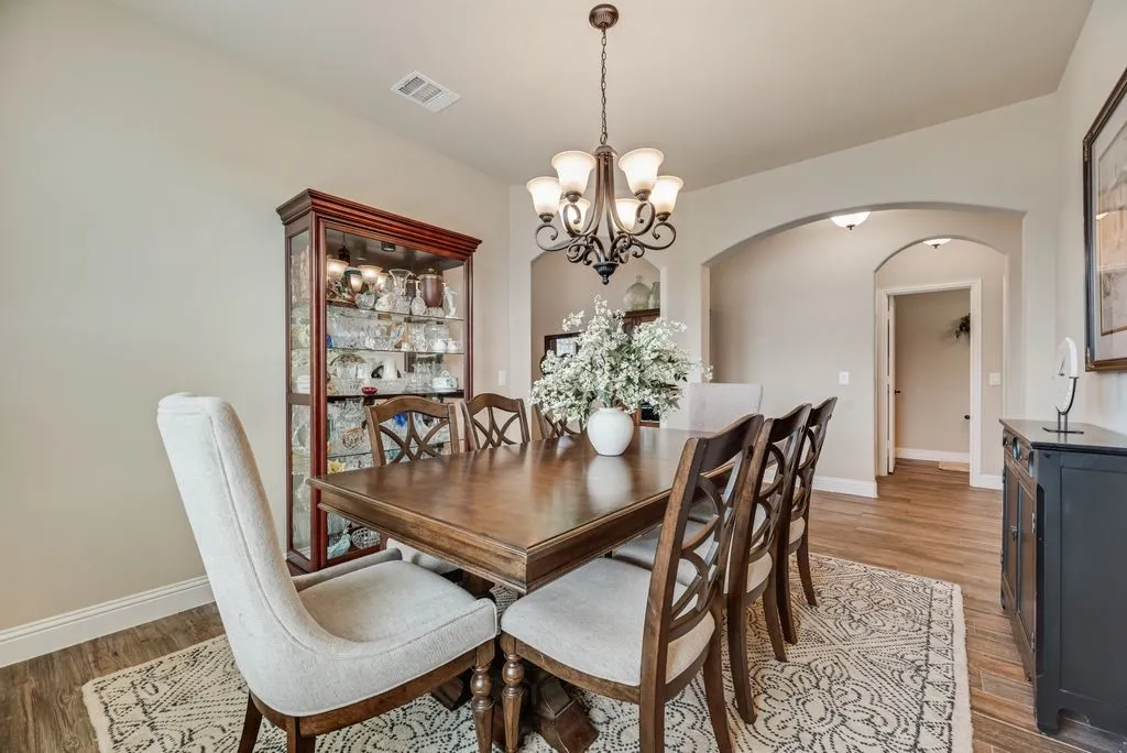 Dinng Area View 4 - Arch openings from Entry Hall - Open Door Straight Across in the other hallway is the Powder Room Half Bath. Turn to Right in that hallway is the Nice Size Laundry Room with Built in Wood Cabinets over the Full Washer Dryer Area