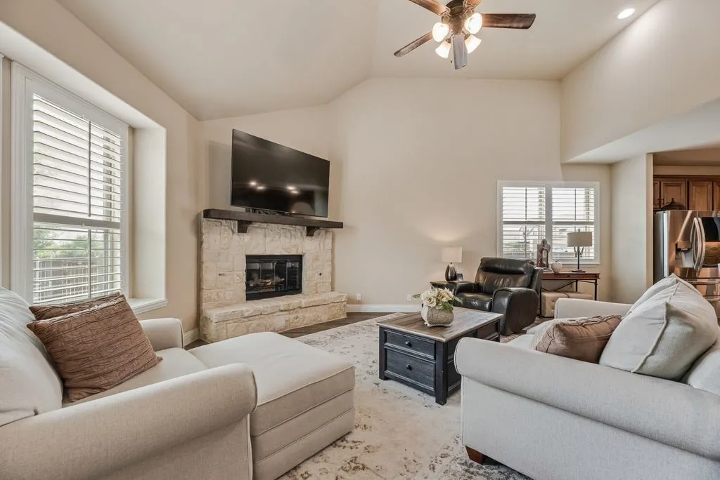 Living/Family Area Partial View at Angle - Stone Gas Fireplace with Stained Mantle, 3.5 inch Shutter Blinds, 5 inch Baseboards, and Extended Window Sill the Back Window (per builder specs when home built it was called a
Window Seat) - All Window have Screens.