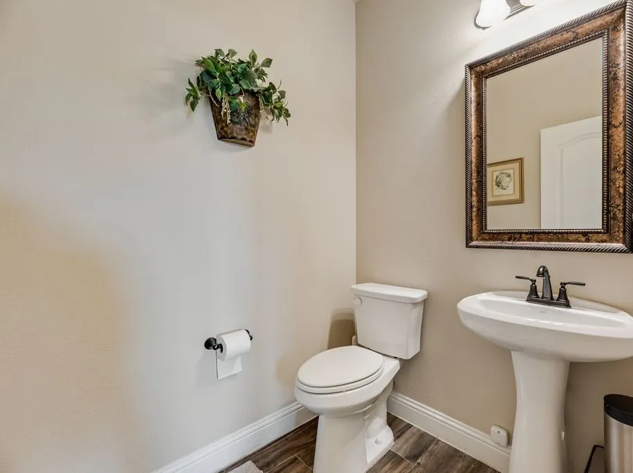 Powder Room - Half Bathroom on first level - Decorative Lighting and Framed Mirror with Pedestal Sink