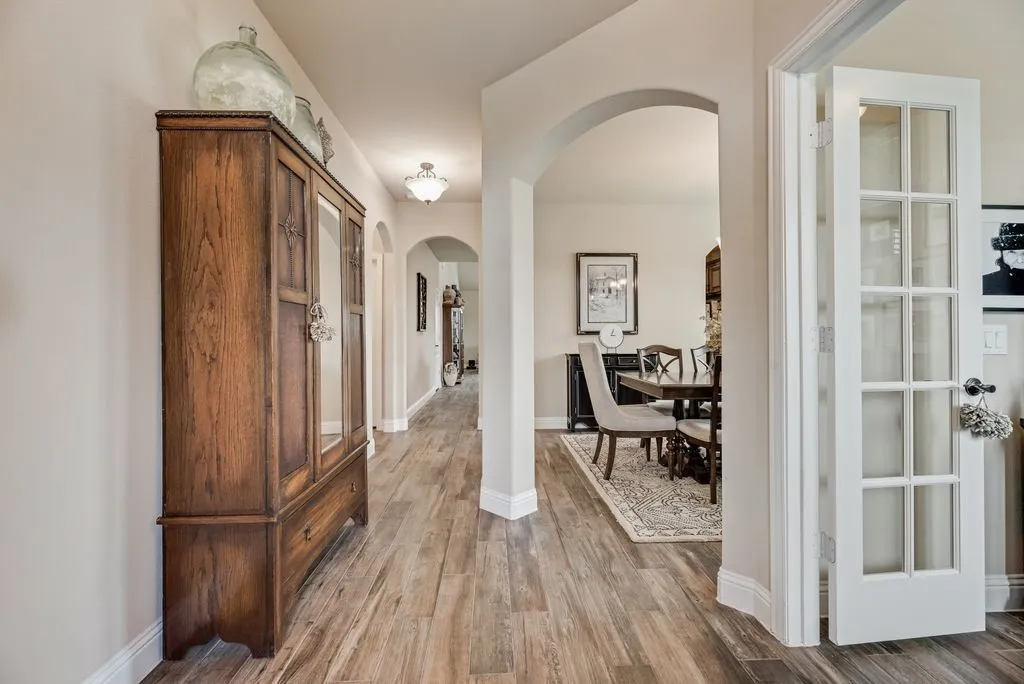 Entry Hallway - Wood  Look Ceramic Tile, Archways into Dining Area, French Doors into the Study/Office Area.