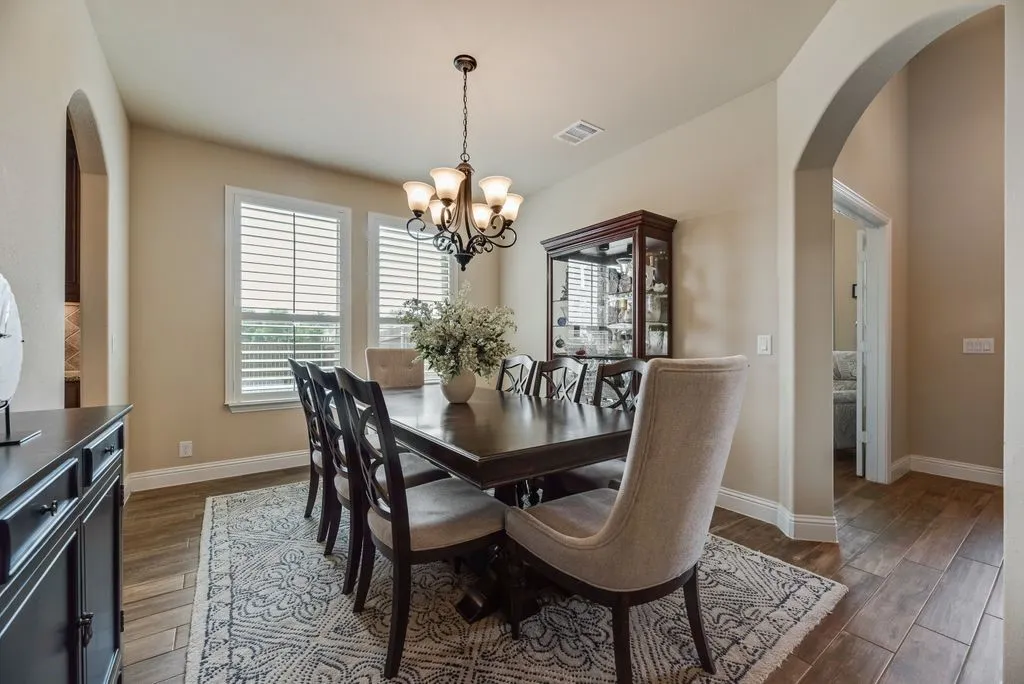 Dining Area View 1- Open Dining Area toward Decorative Chandelier to Windows with 3.5 inch Shutter Blinds added in 2023