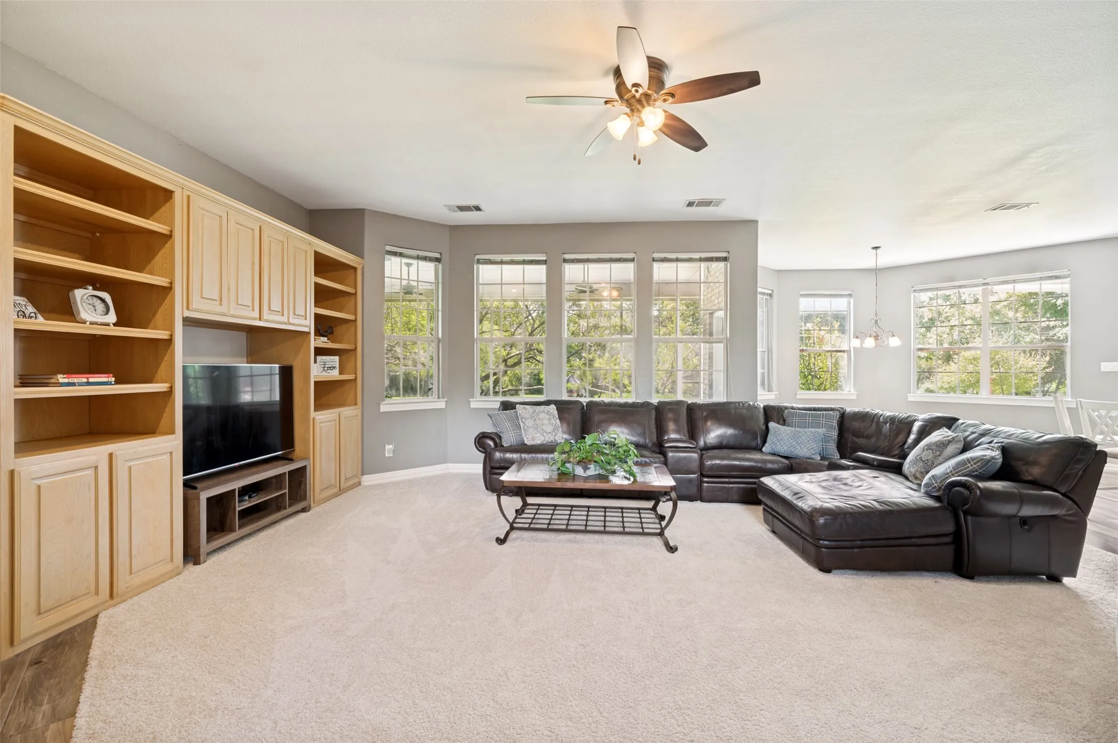 Family room with wall of windows and view of backyard