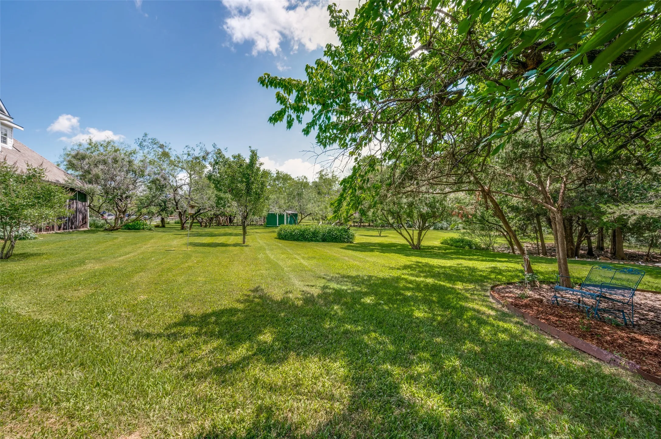 This view of the property is looking from the south side to the north side and includes a little sitting area