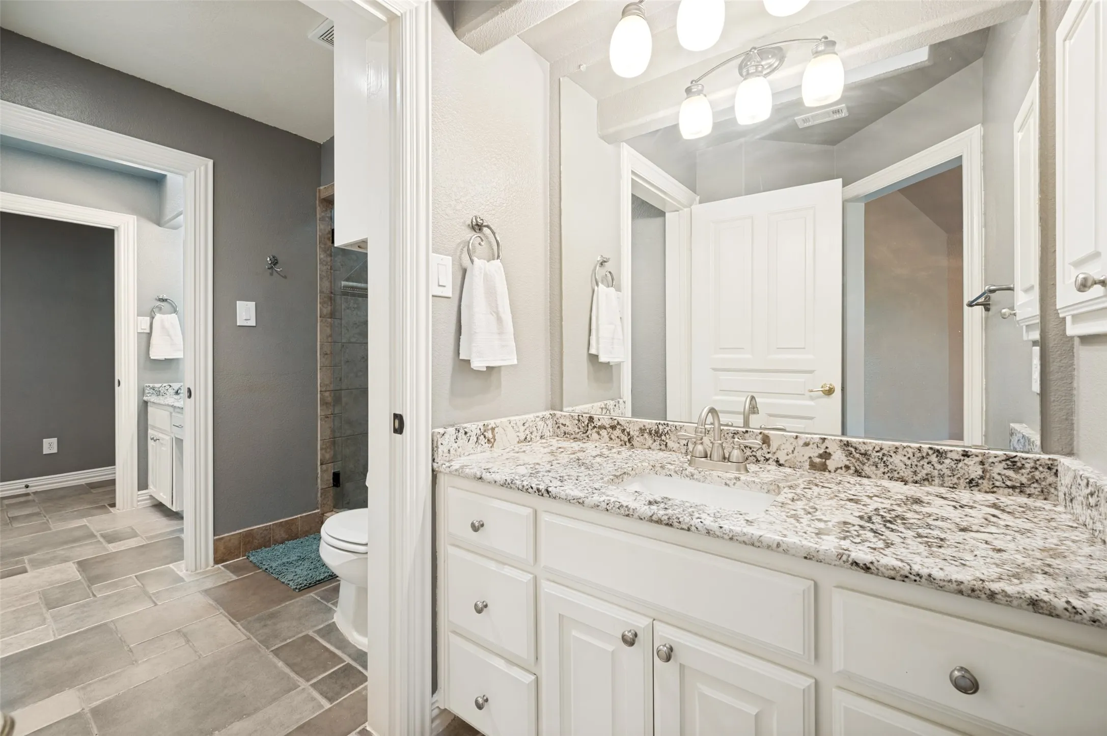 Upstairs bath is connected to hallway and one of the bedoroms.  It has two separate vanities and a shower.