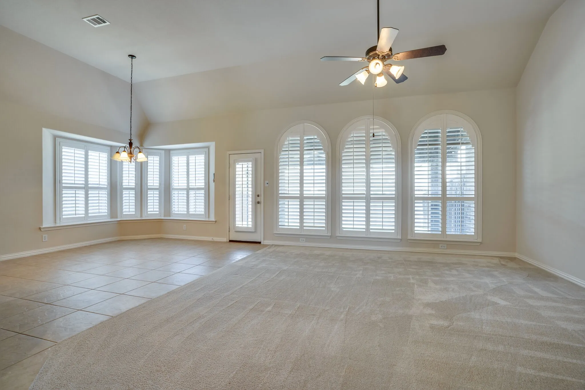 Large custom windows throughout with plantation shutters