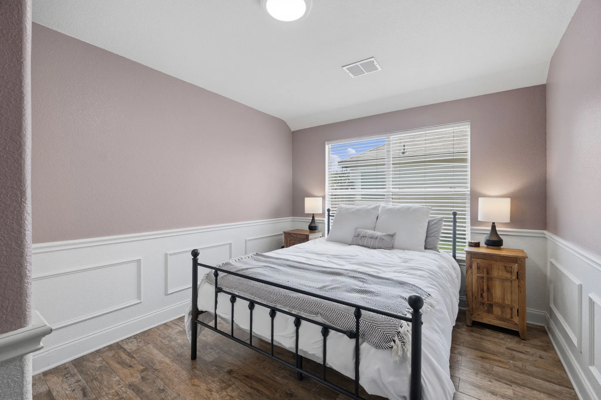 Interior featuring wood-finish flooring, paneled wainscoting, a window with horizontal blinds, and a ceiling-mounted light fixture