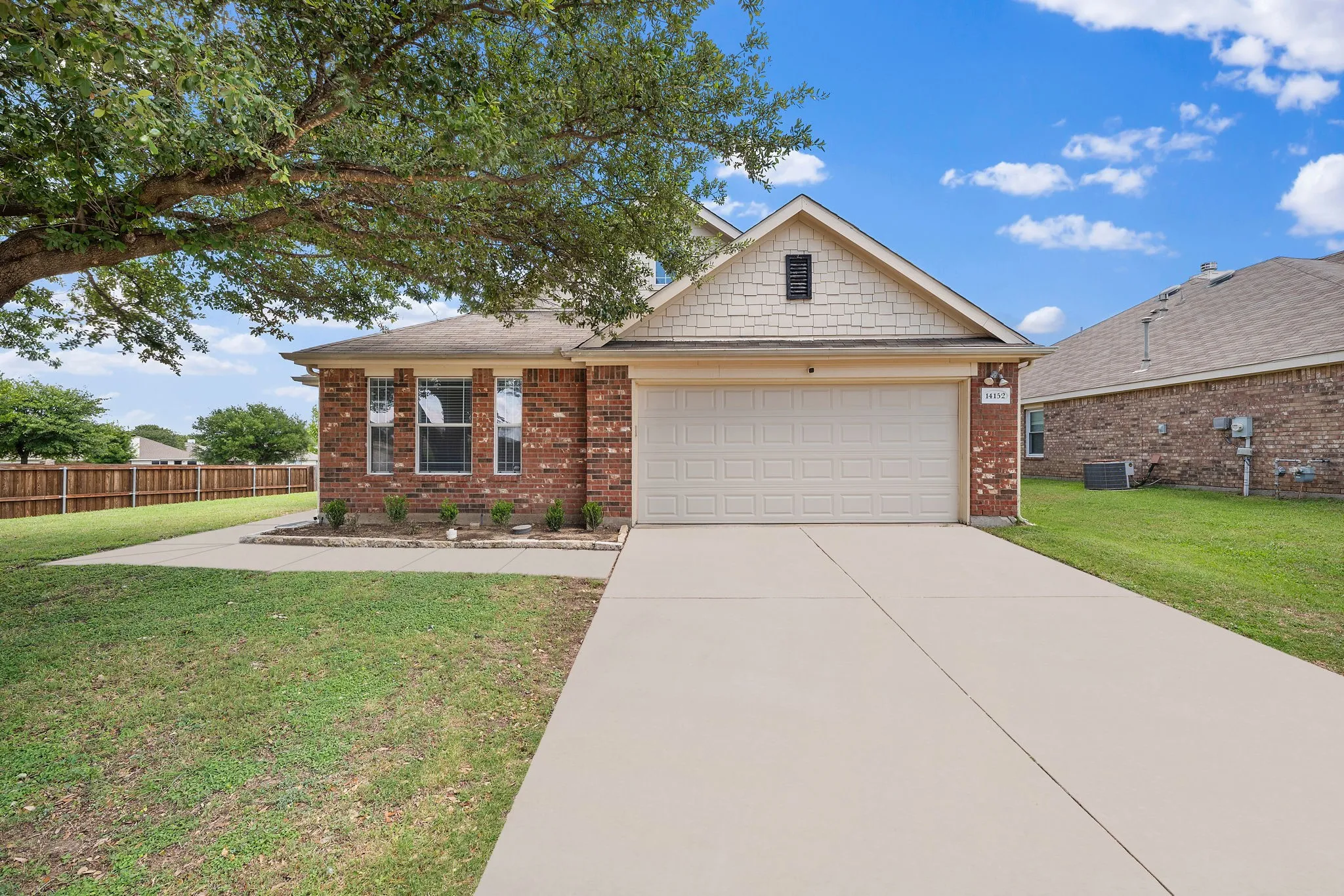 Brick exterior with a prominent front-facing garage