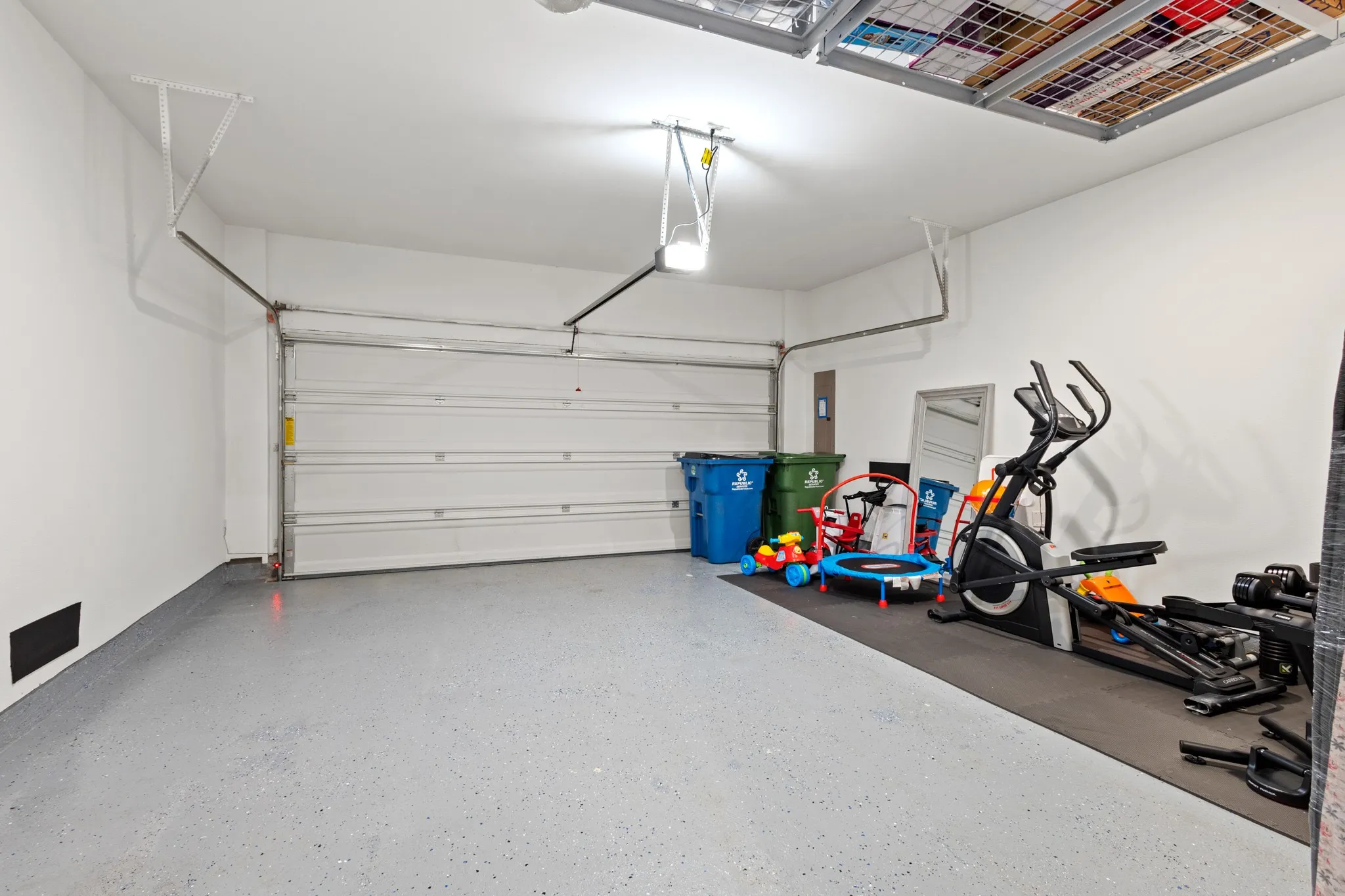 Spacious 2-car garage with premium epoxy-coated flooring, high ceilings, and generous storage space -- one of the standout owner-added upgrades in this exceptional townhome.
