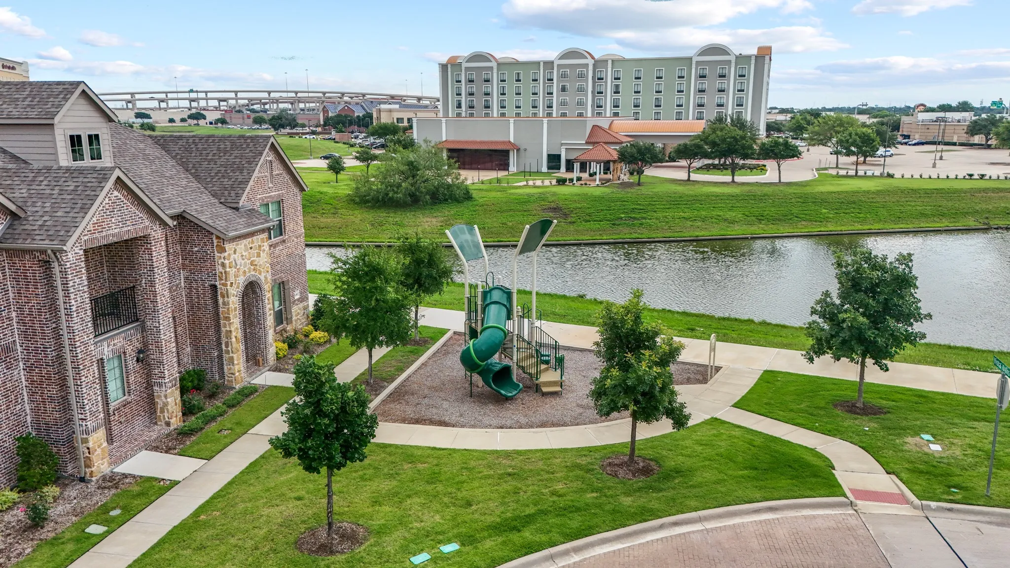 Bird's-eye view capturing the serene canal, lush greenery, and well-planned layout that make Vista Del Lago one of Lewisville's most desirable and livable communities.
