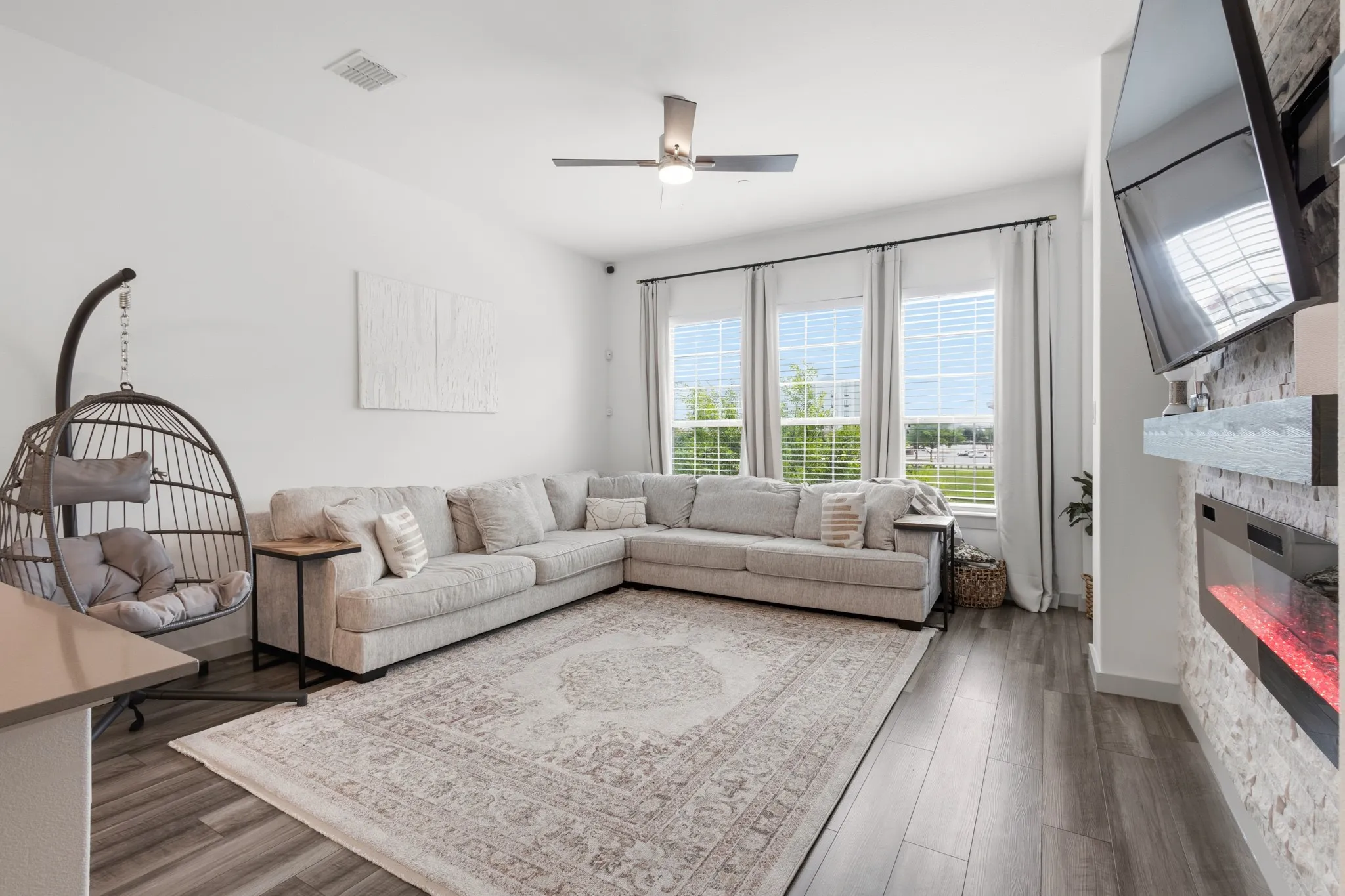Bright and airy living space with large windows filling the room with natural light, comfortable seating area, and beautiful views -- perfect for relaxing and everyday living.