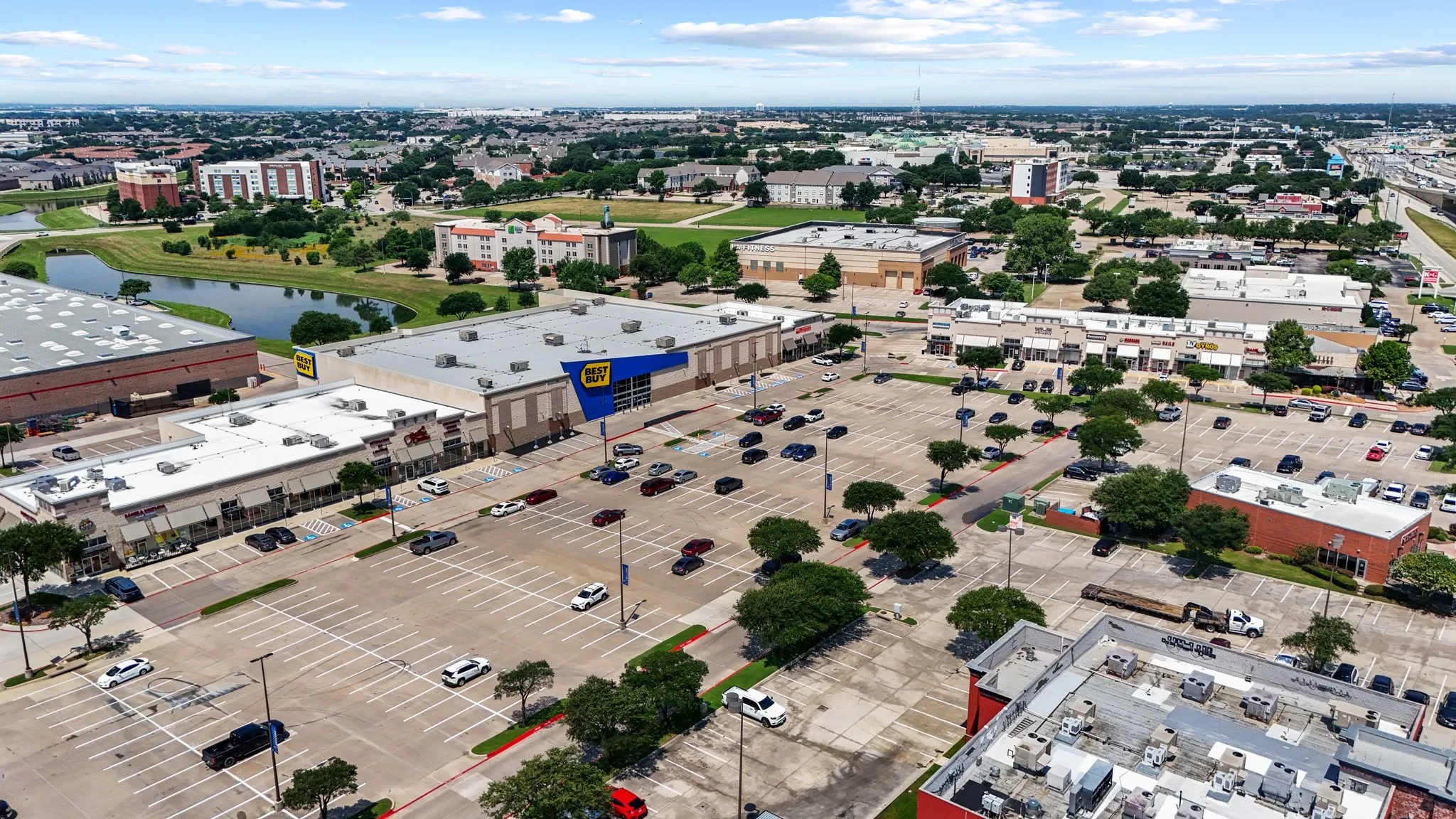 Aerial view of the broader Lewisville area demonstrating the home's proximity to commercial amenities, highways, and the vibrant DFW Metroplex.