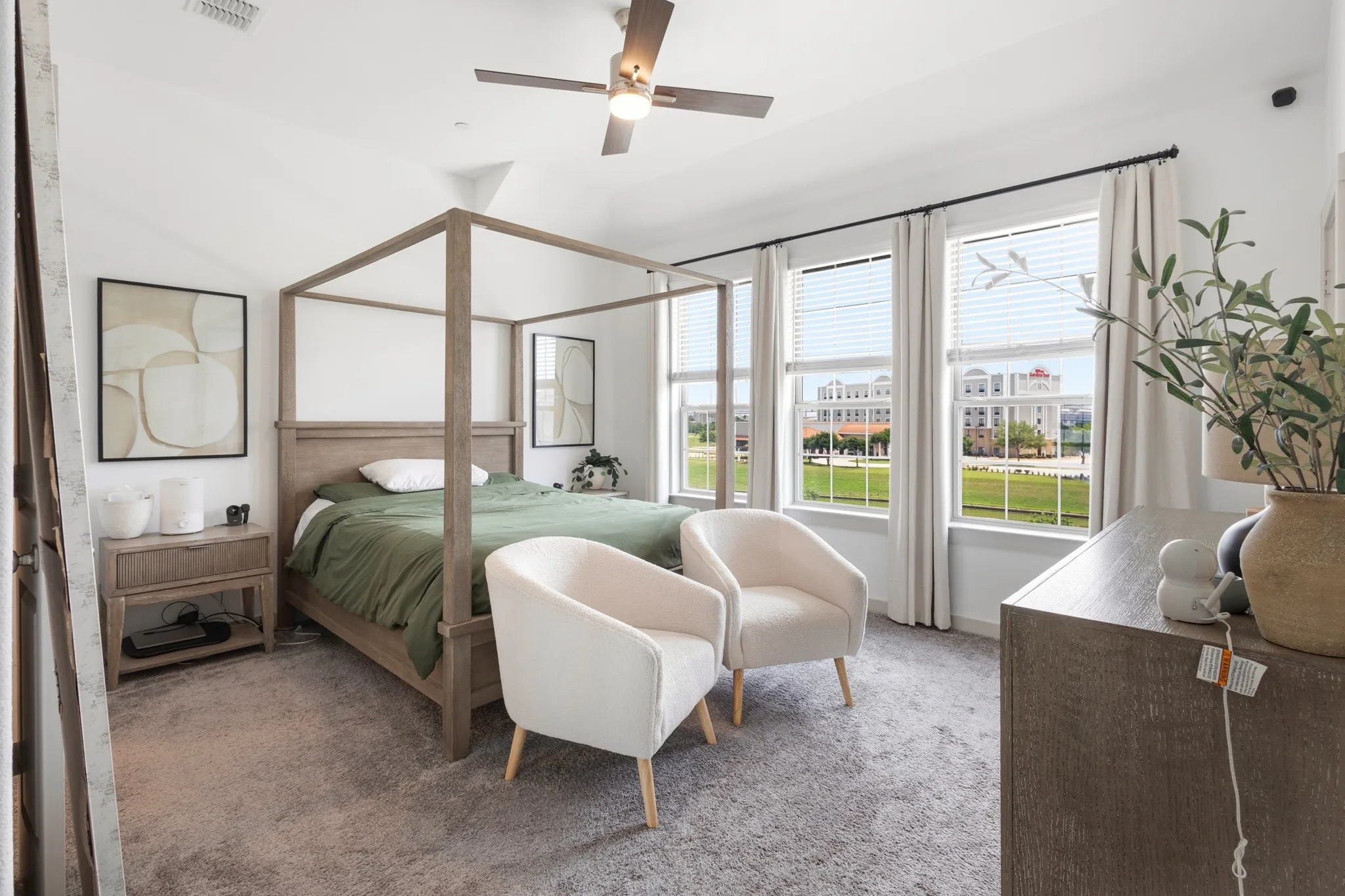 Generously sized primary suite offering a canopy-bed-ready layout, triple window arrangement with canal views, and luxurious appointments throughout -- your private sanctuary at day's end.