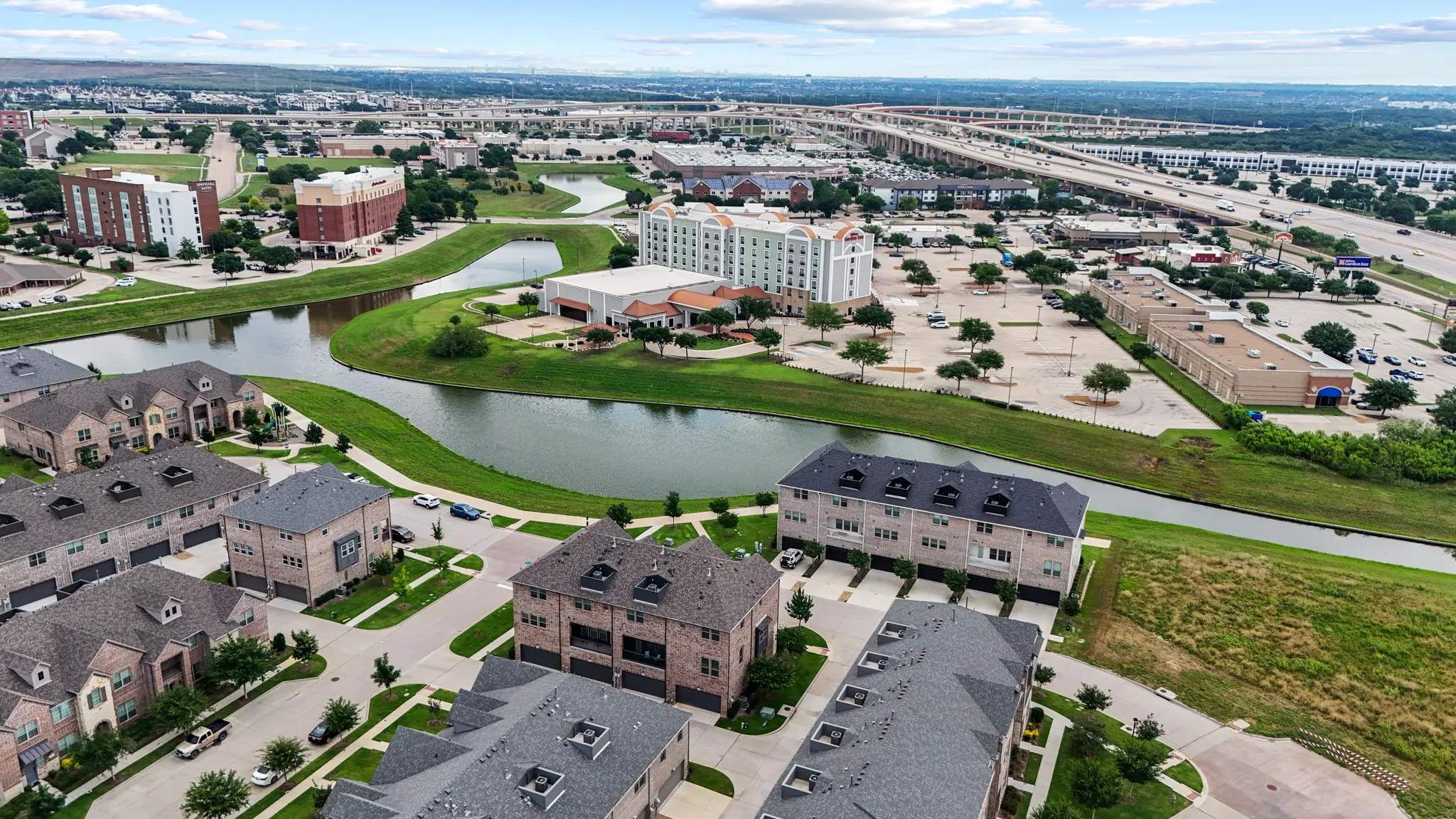 Expansive aerial view of the Vista Del Lago community and surrounding area, highlighting easy access to Hwy 121, premier shopping, dining, and DFW Airport.