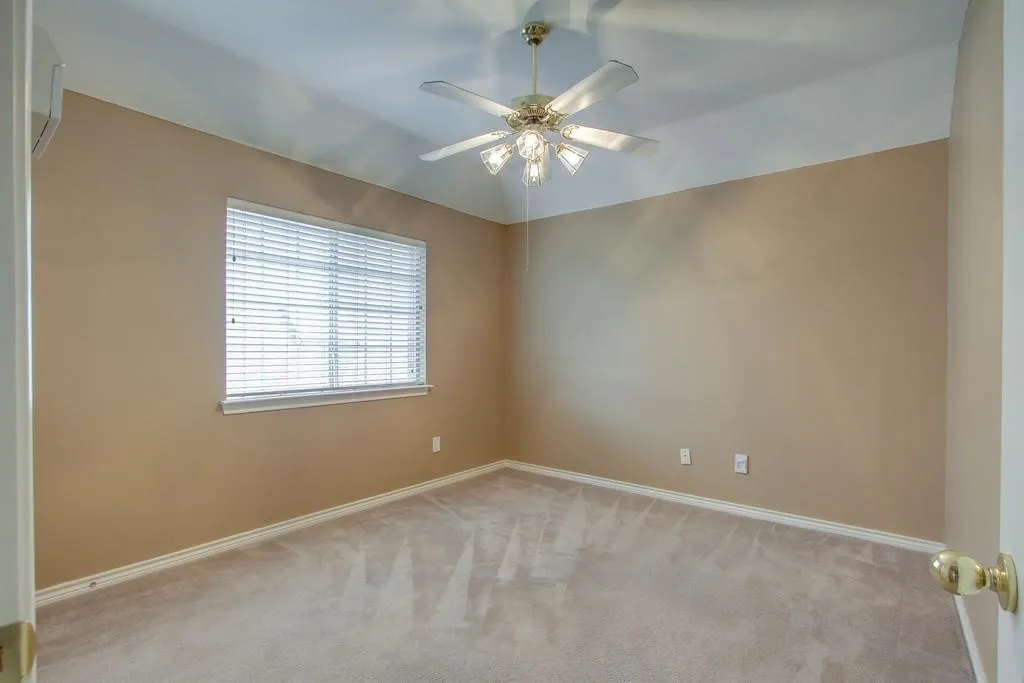 Upstairs. Carpeted room featuring a single window with blinds, a ceiling fan with integrated lighting, and neutral-toned walls