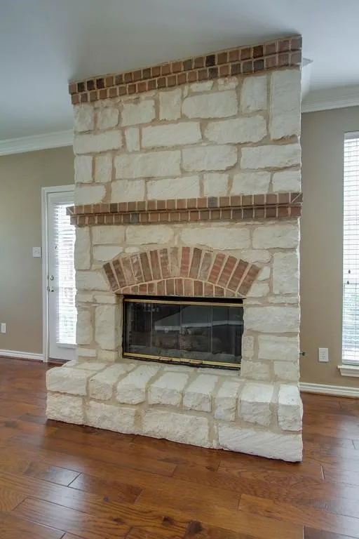 Stone-clad fireplace with brick accents and hearth