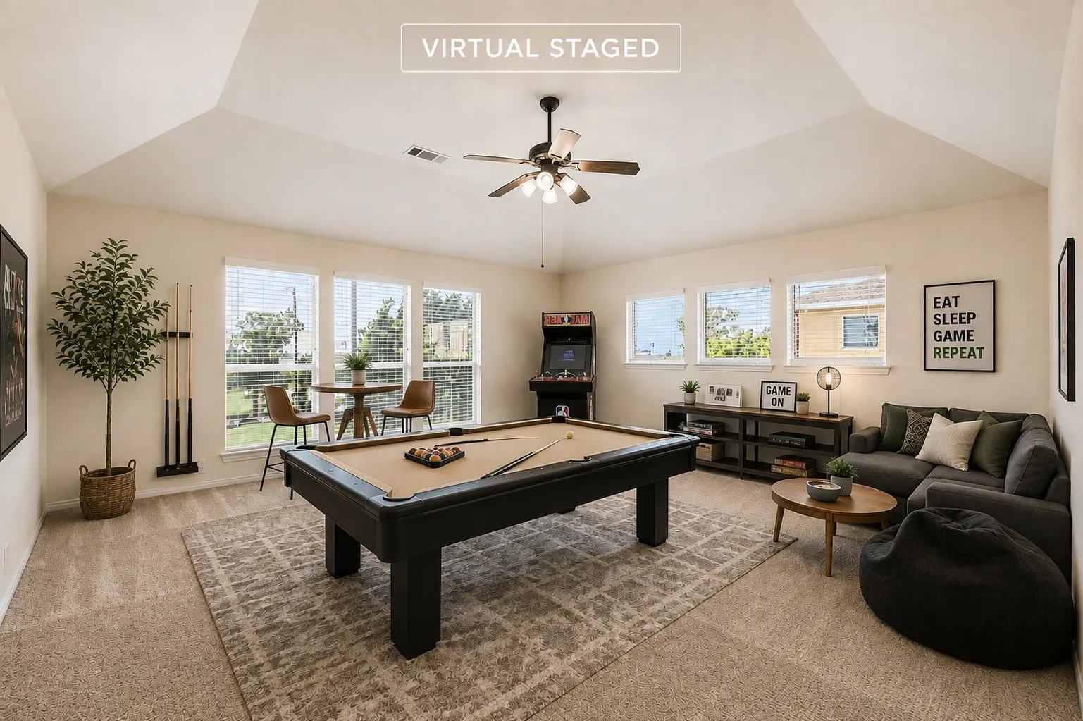 Vaulted ceiling with a ceiling fan, multiple windows with blinds, and neutral carpet flooring
