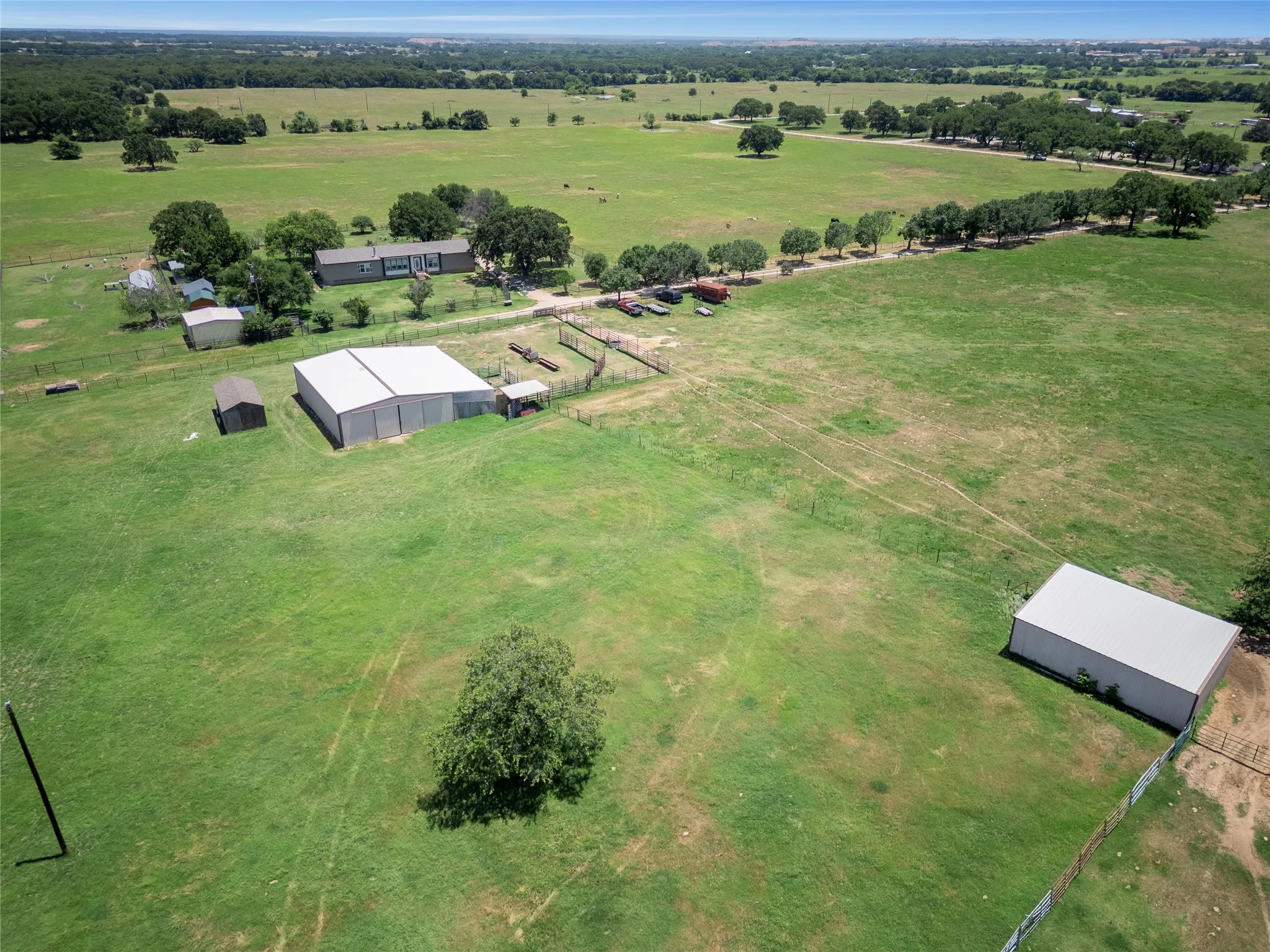 Cross fencing, cattle chutes, haybarn with plenty of pens for chickens and goats. Mobile home could be a foreman's home or living area while you build your Ranch home.