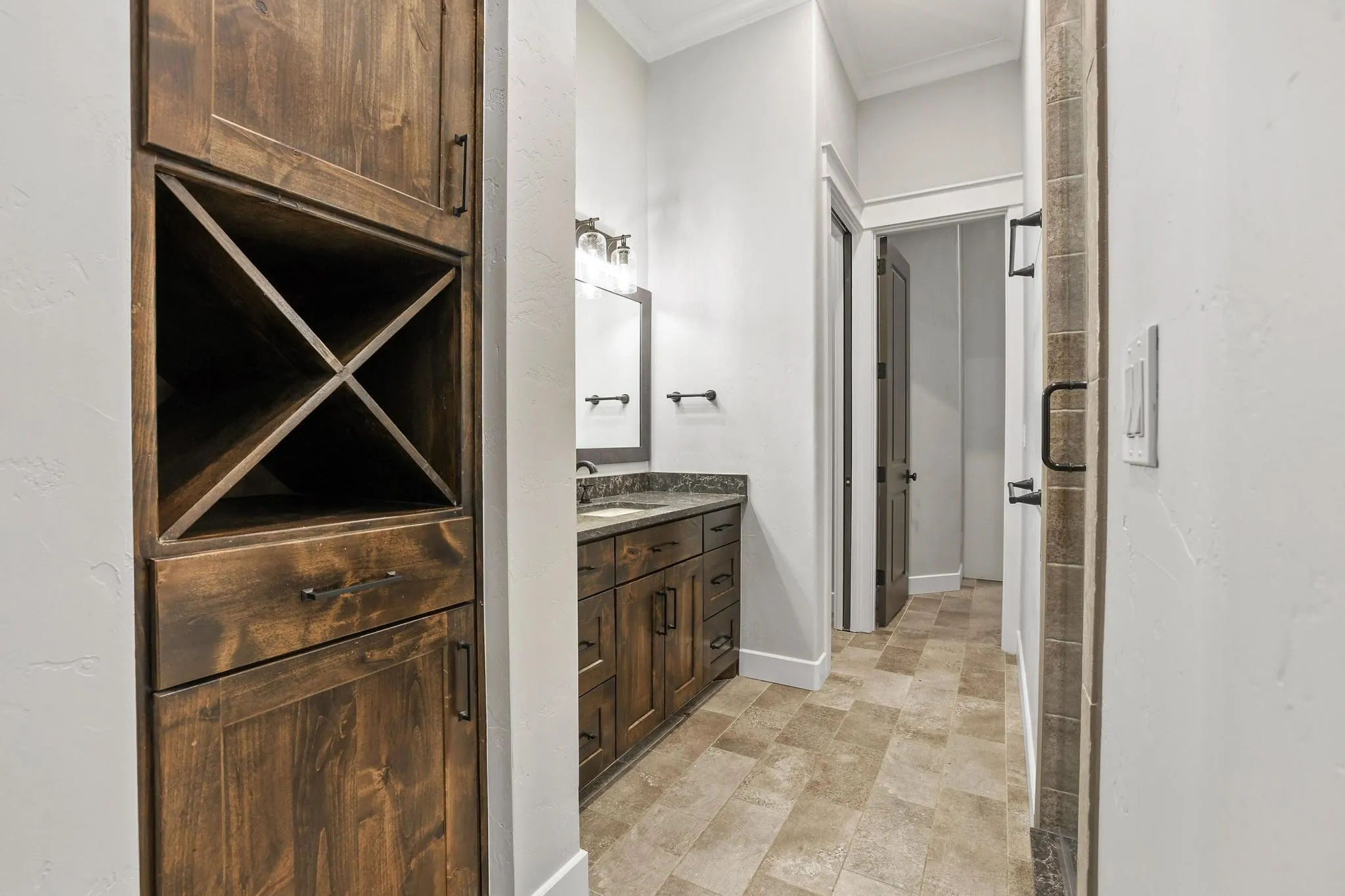 Custom dark wood storage cabinet with an integrated wine rack
