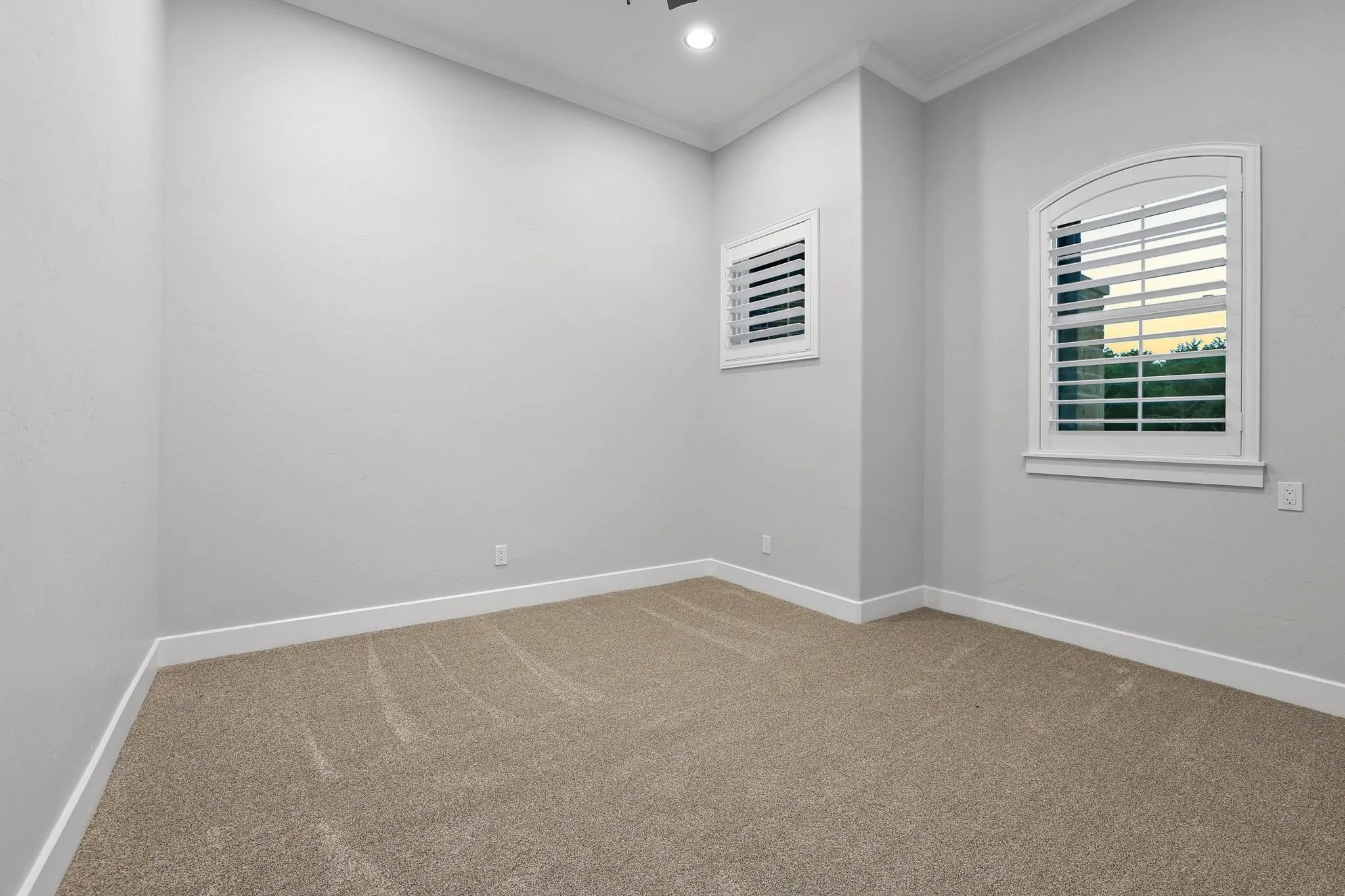 Room featuring light gray painted walls and neutral carpet flooring