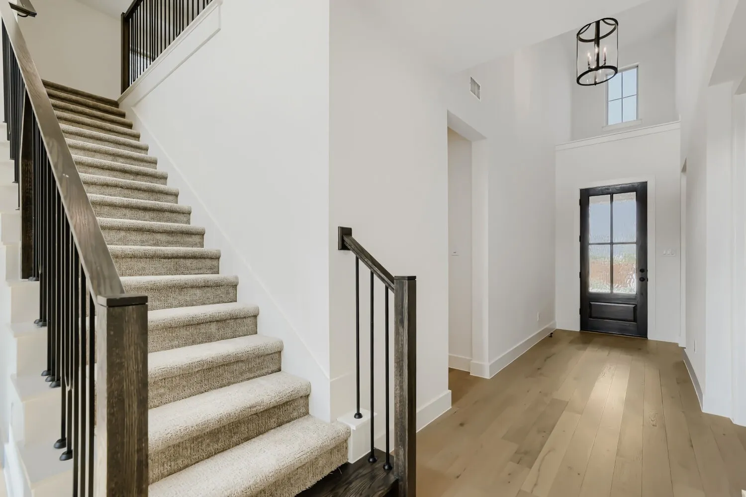 Bright foyer with soaring ceilings and abundant natural light