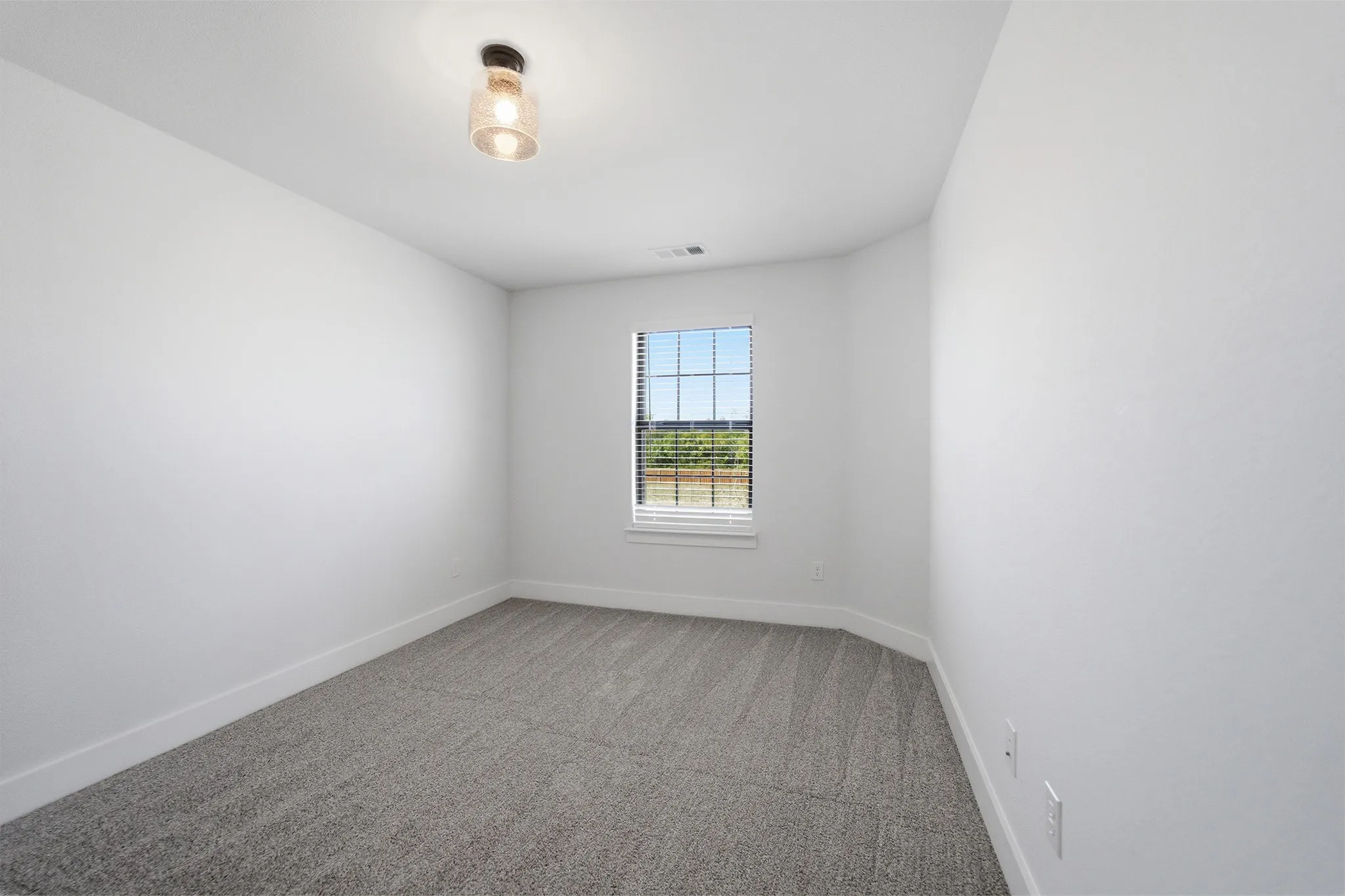 Room featuring light gray carpet, white walls, and a single window with horizontal blinds