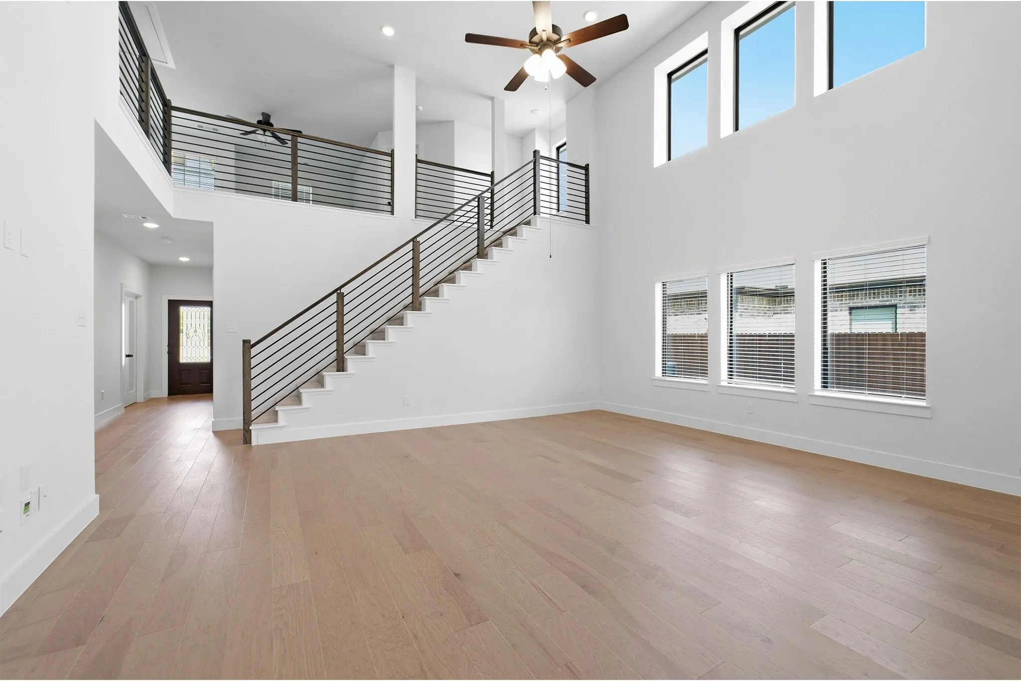 Two-story living area with wood-finish flooring
