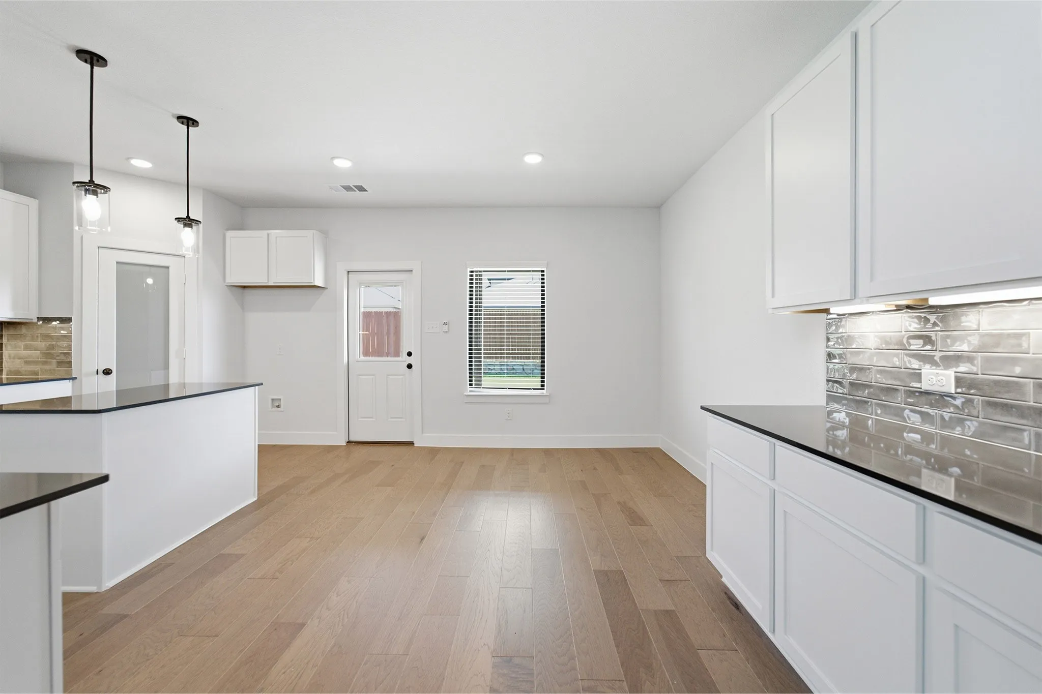 Open concept kitchen and dining area with wood-finish flooring