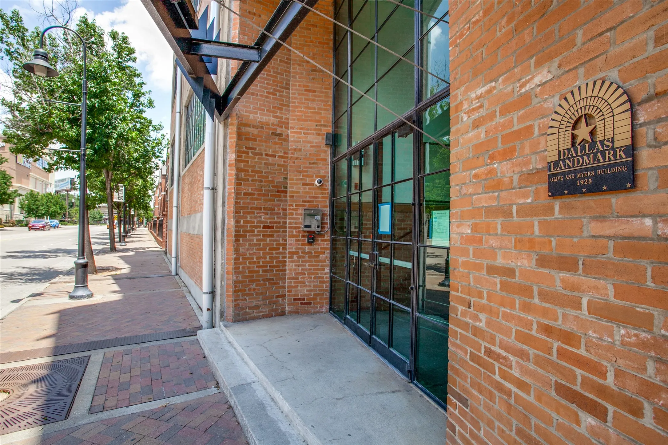 Brick facade building entrance featuring a Dallas Landmark plaque