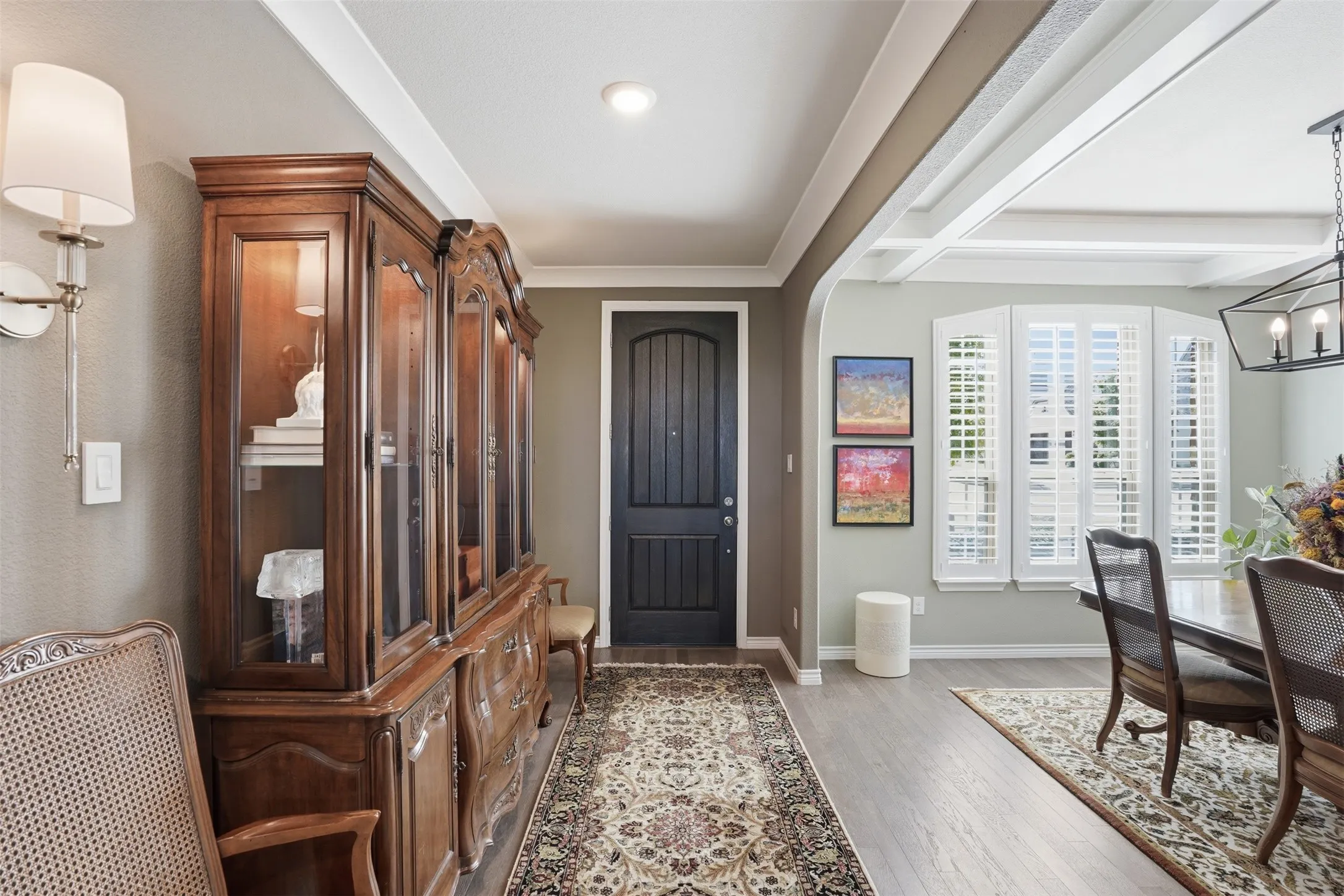 Entryway featuring wood-finish flooring, recessed lighting, and a dark paneled door