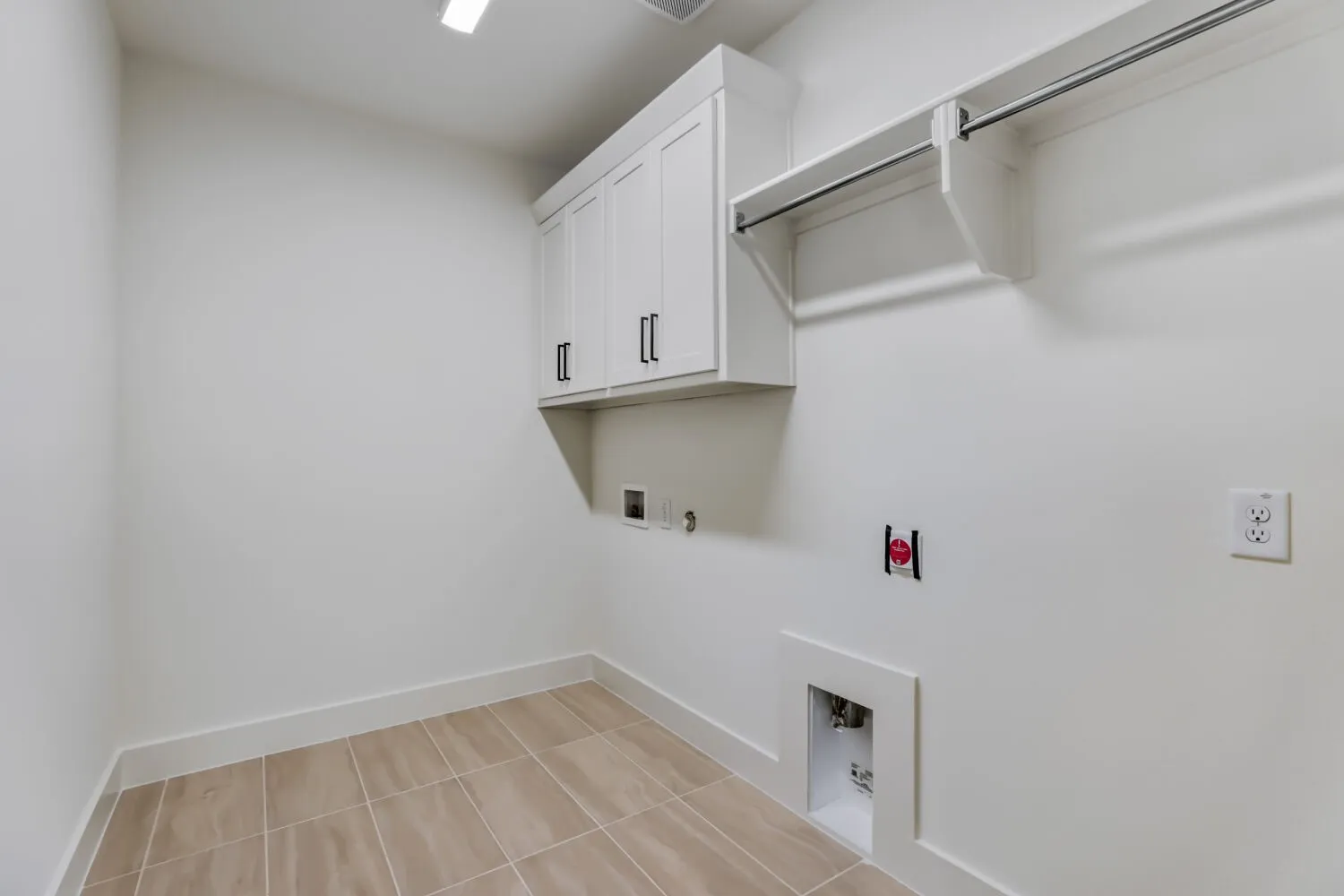 White shaker-style cabinetry with matte black pulls