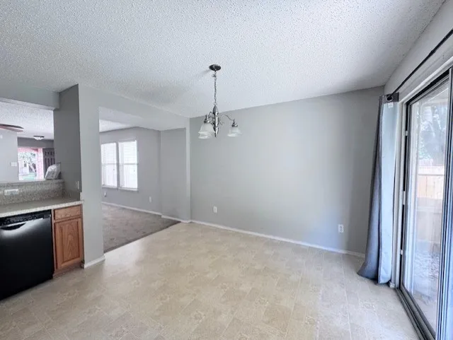 Dining area featuring neutral wall paint, a ceiling-mounted light fixture, and tile-finish flooring