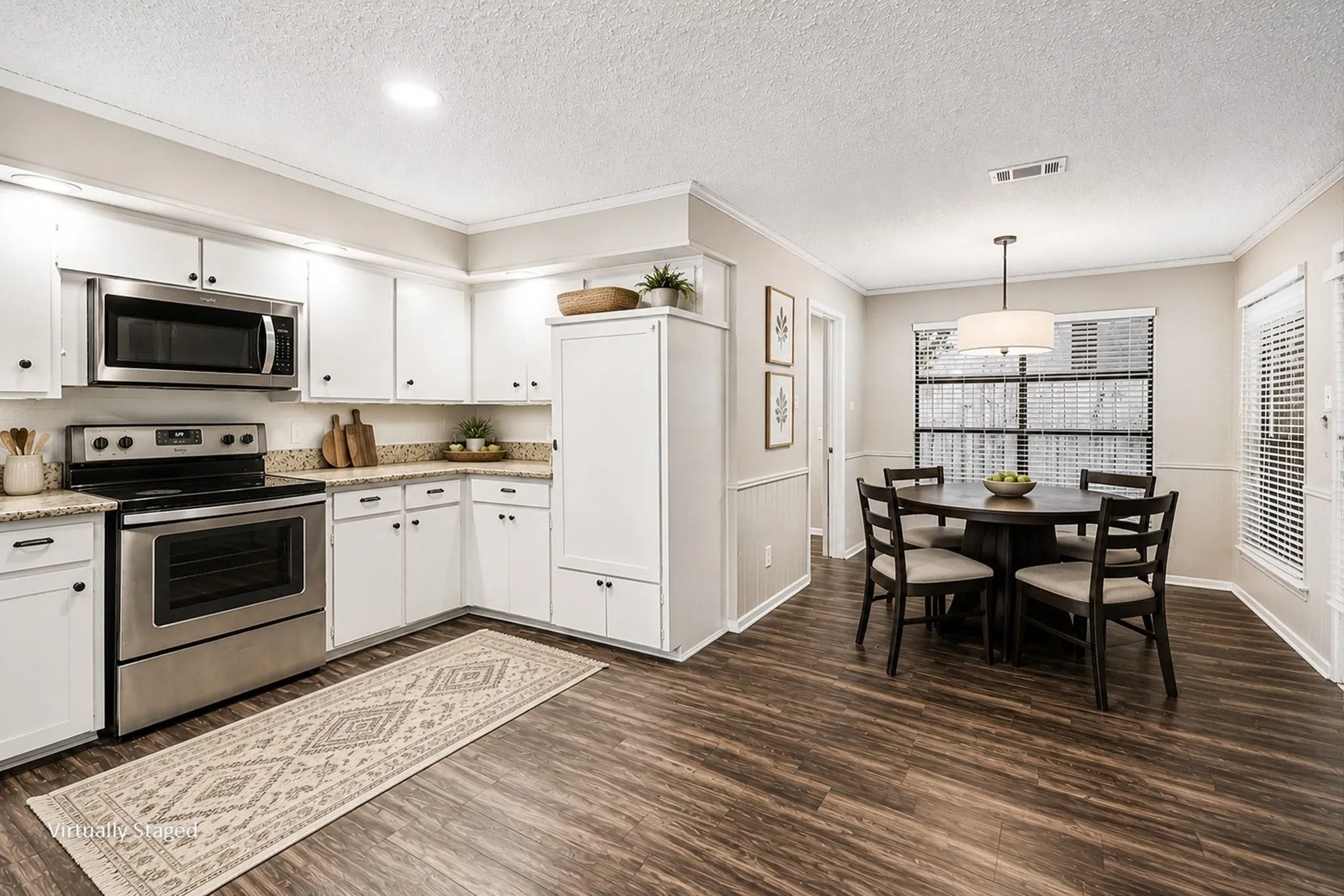 Virtually staged eat-in kitchen with a breakfast area.
