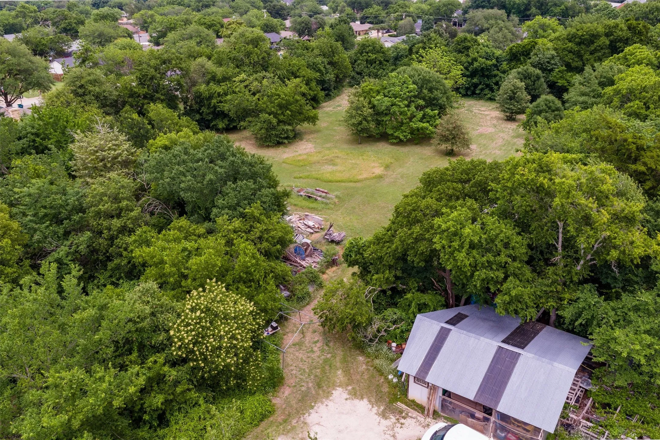 Expansive lot featuring a mix of mature trees and open grassy areas