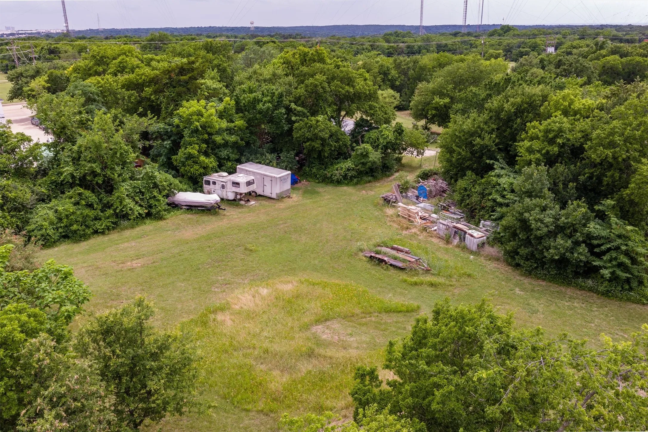 Expansive wooded lot featuring a large grassy clearing and mature trees