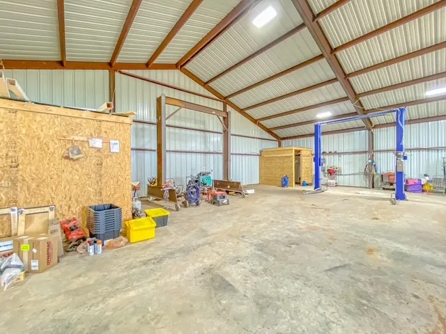 Gantry and 1100 pound automotive lift.  2 post lift only 3 or 4 years old, has only had 4 vehicles on it will convey with the property. Also shown is an extra room as well as a bathroom plumbed and ready to go.