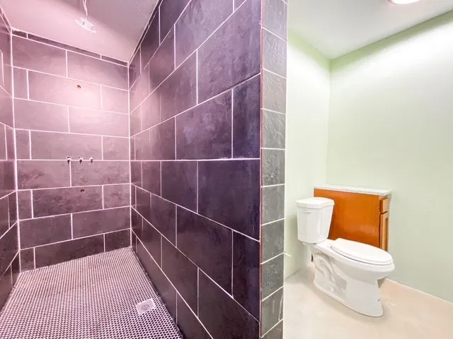 full bath with ceramic and penny tile mosaic walk in shower, rainforest shower head and two high shower spickets and wand (all fixtures are on site)