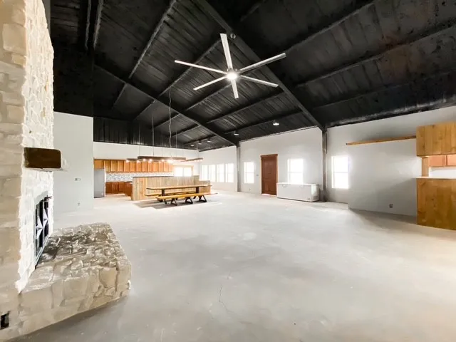 Great big living room showing the angle of the dining room, kitchen, bar area and front door